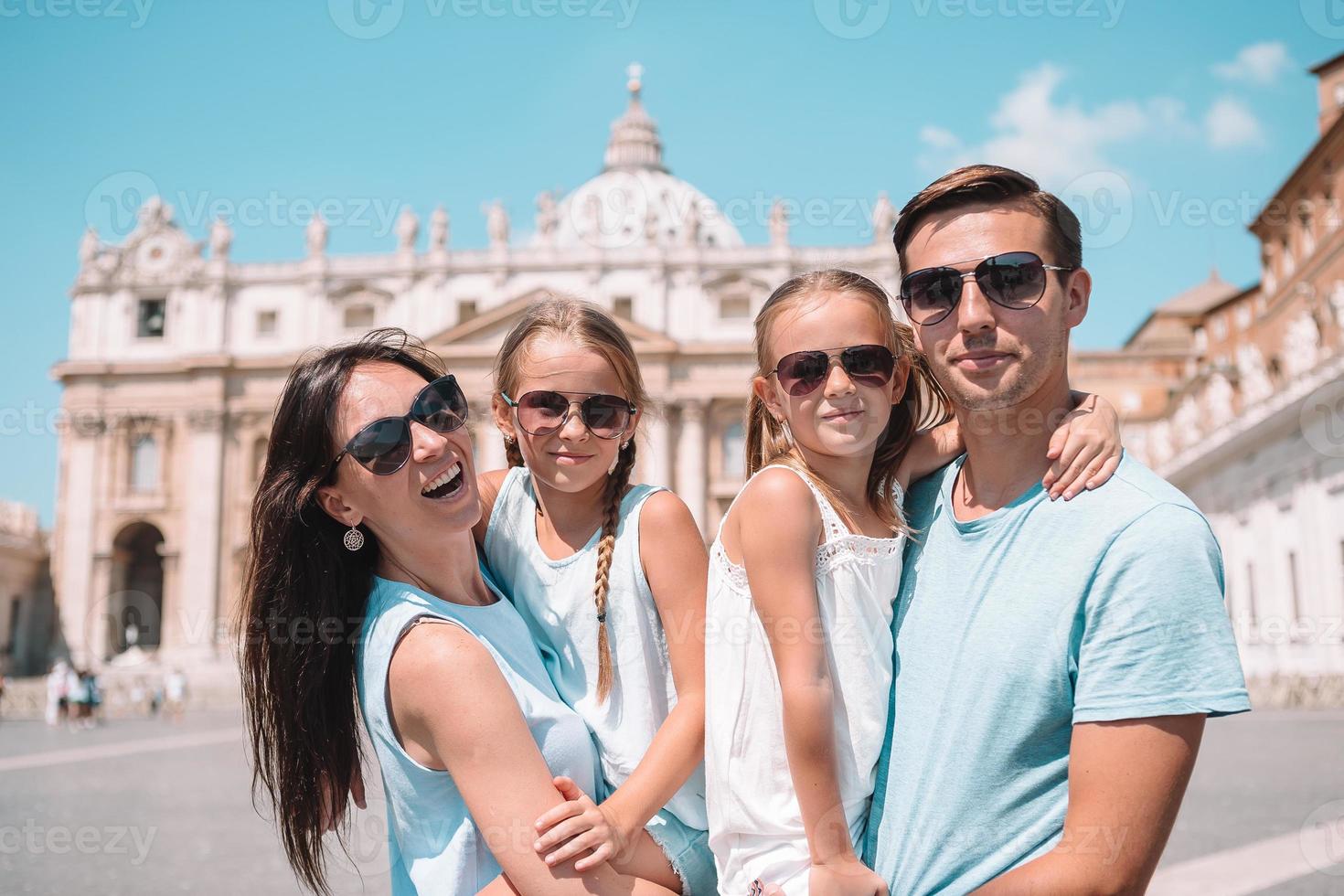 Happy family at St. Peter's Basilica church in Vatican city. photo