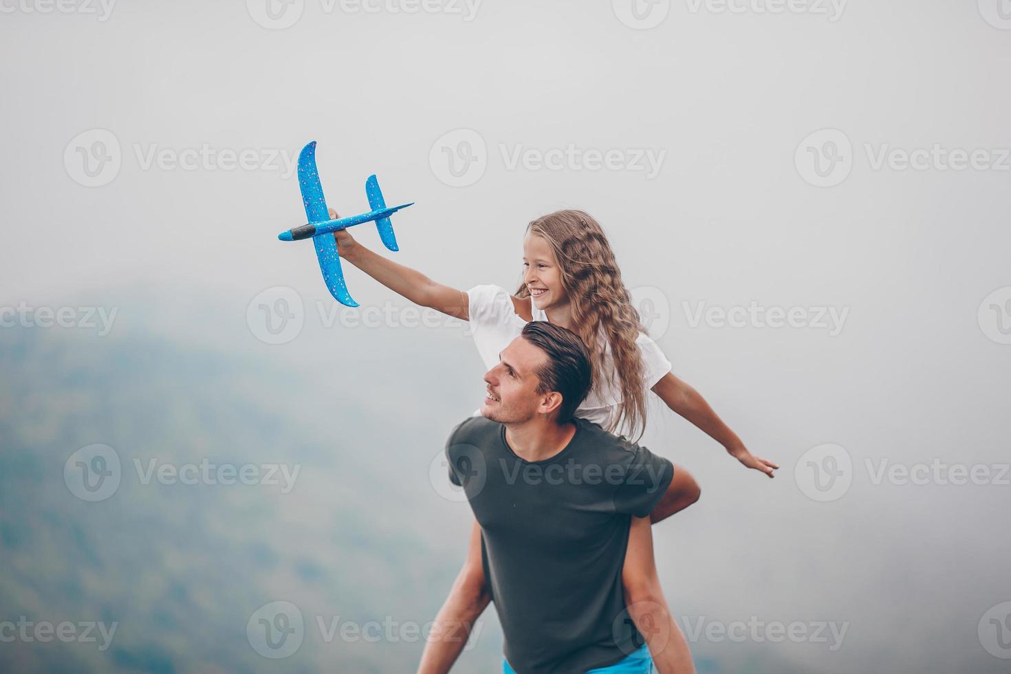 Beautiful happy family in mountains in the background of fog photo