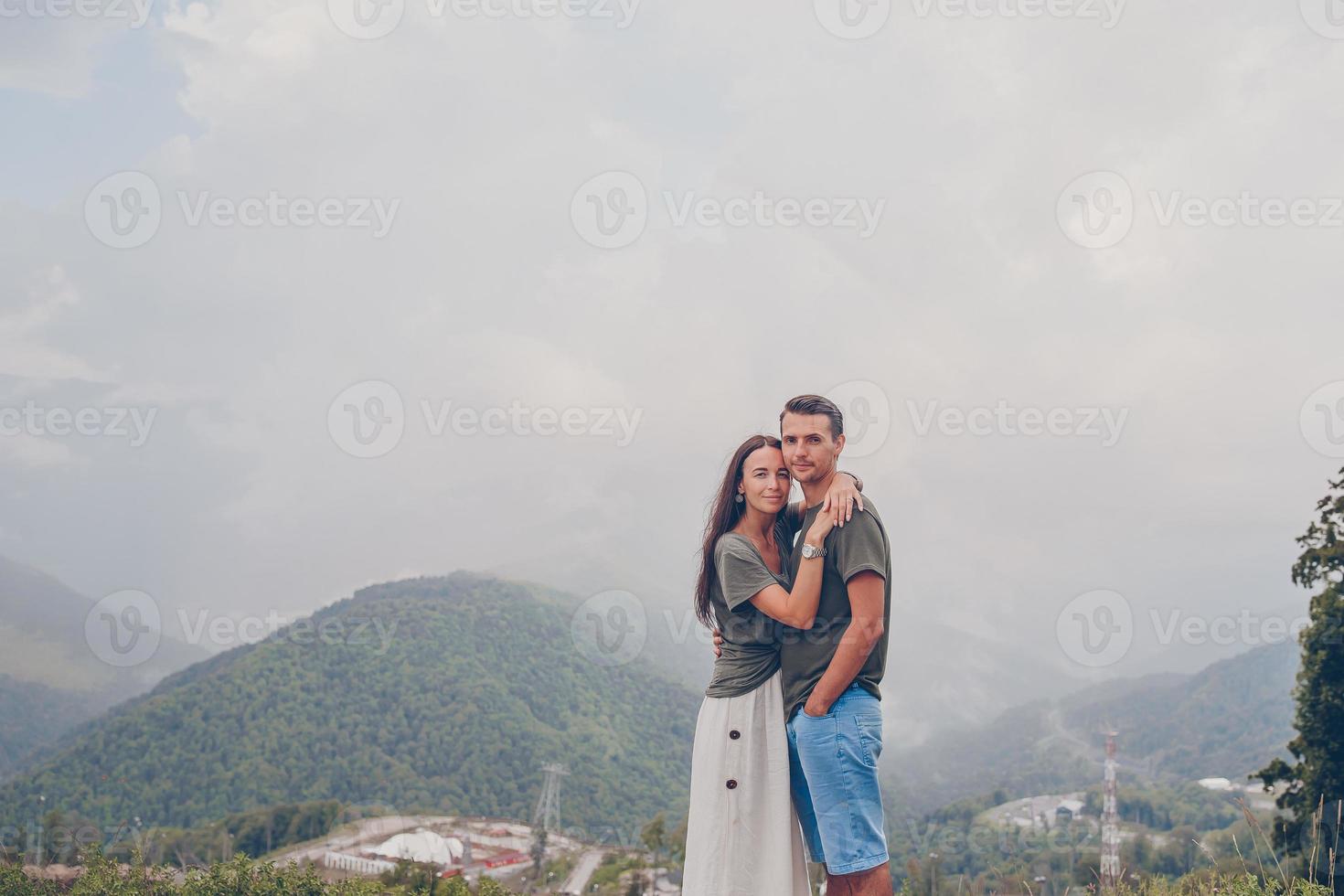 Beautiful happy family in mountains in the background of fog photo