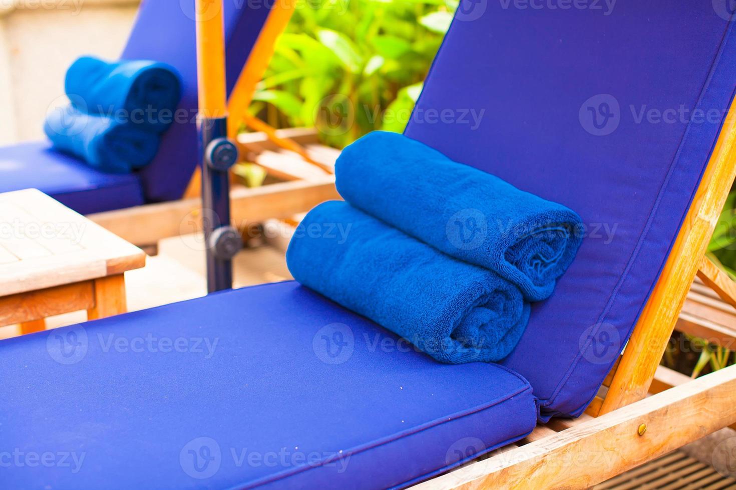 Close-up of towels near swimming pool at tropical resort photo