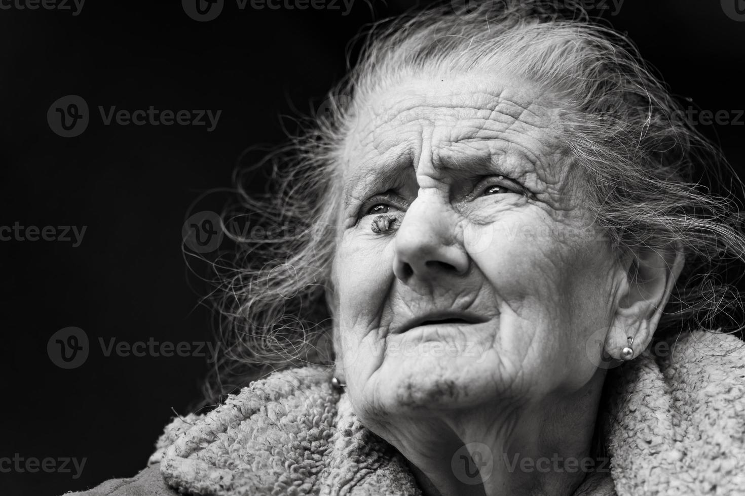 Very old and tired wrinkled woman outdoors photo