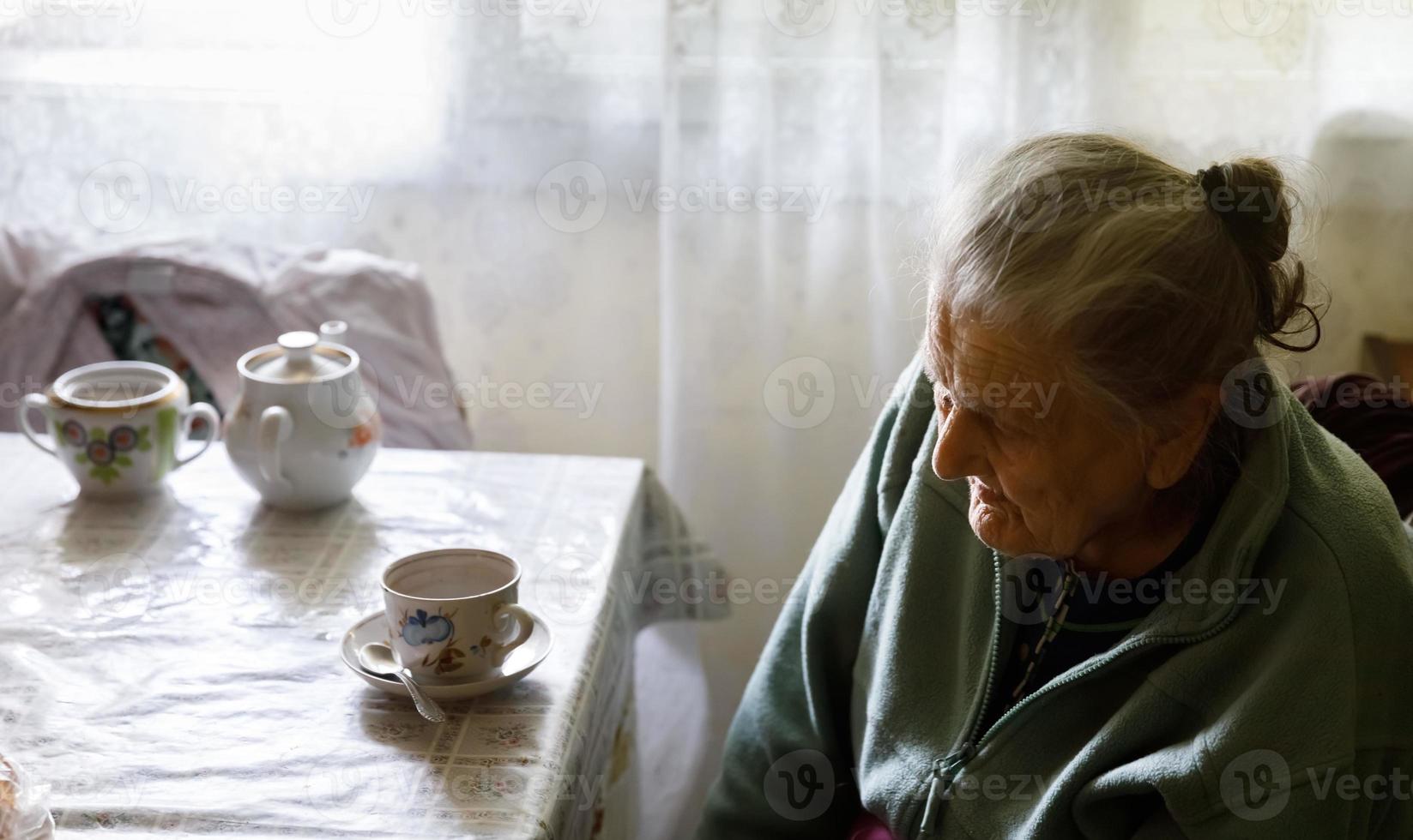 Elderly lonely woman photo