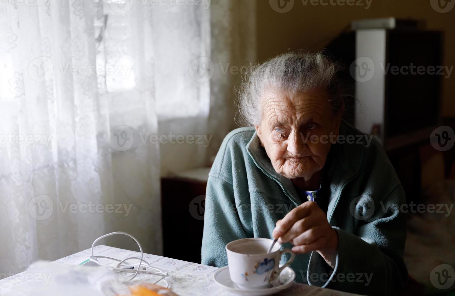 Elderly lonely woman photo