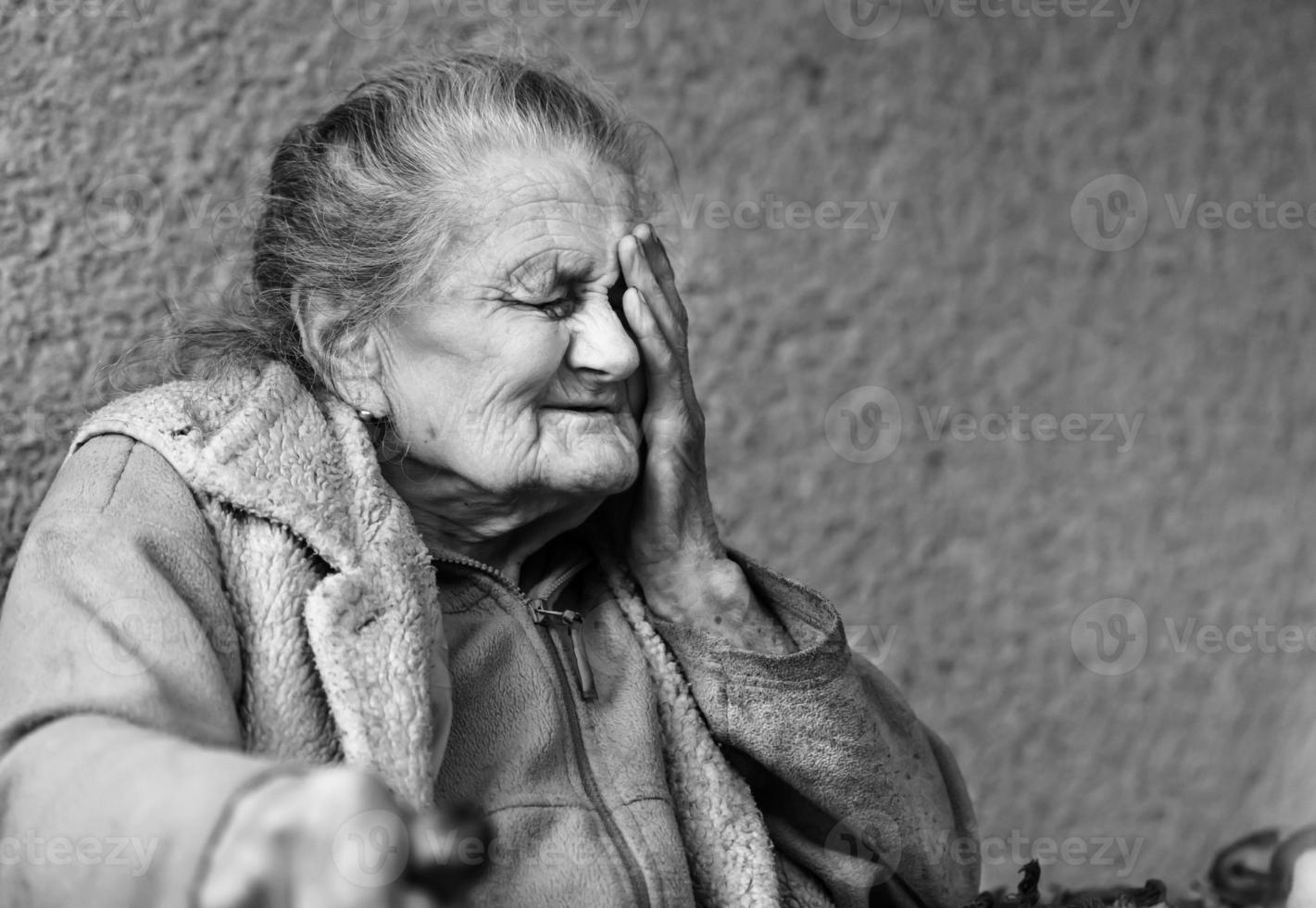 Very old and tired wrinkled woman outdoors photo