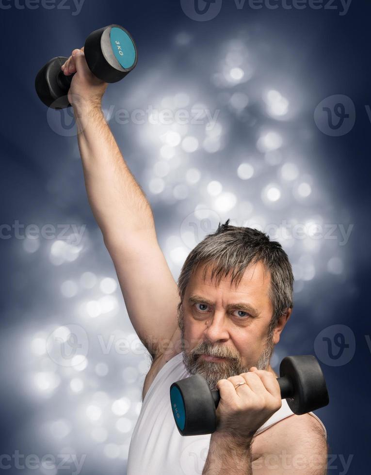 man exercising with dumbbells photo