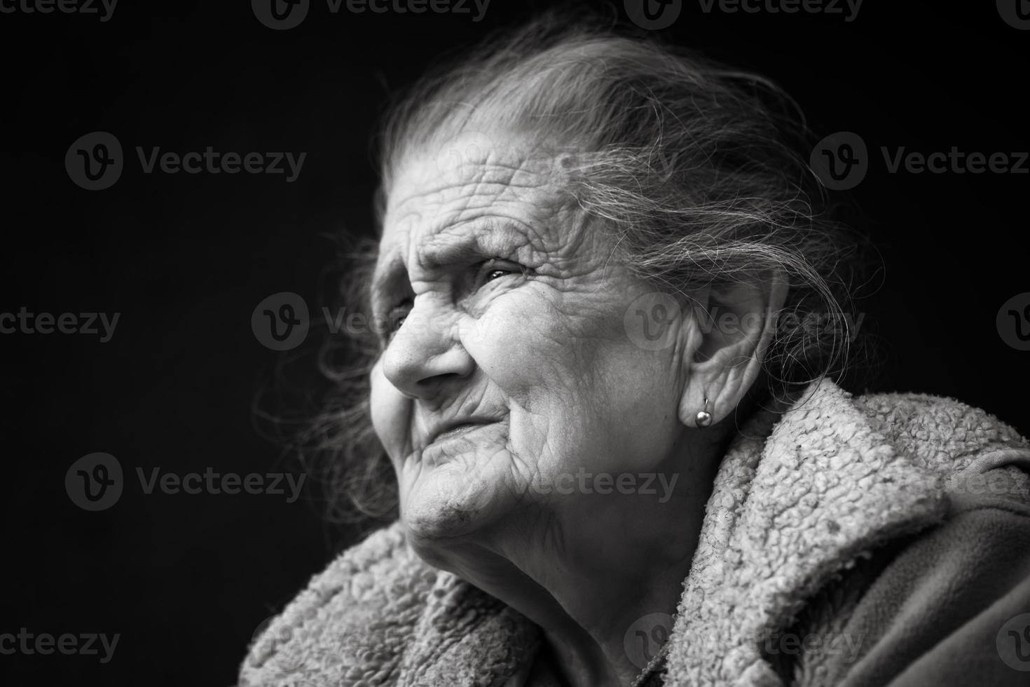 Very old and tired wrinkled woman outdoors photo