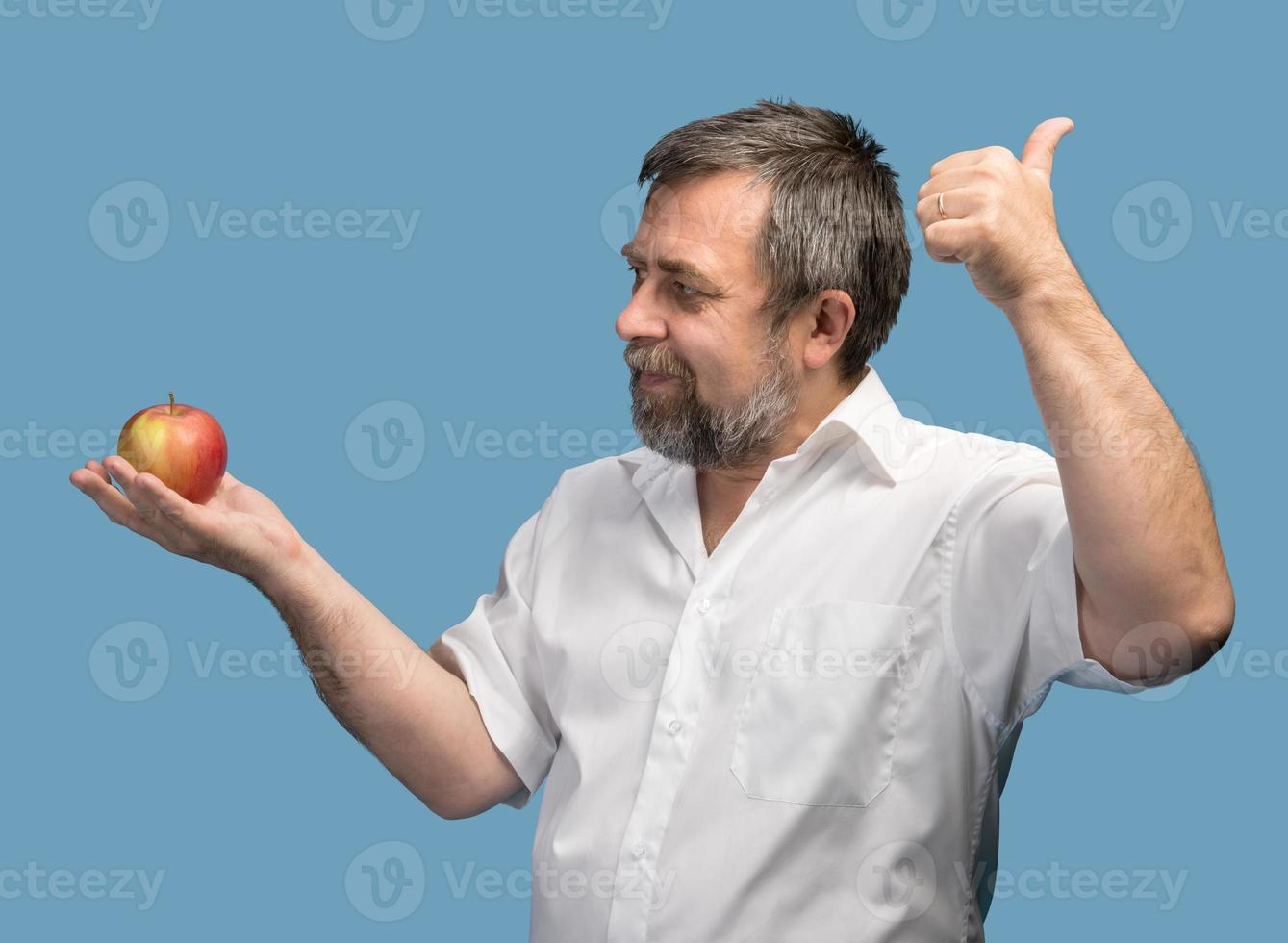 middle-aged man in white shirt with red apple photo