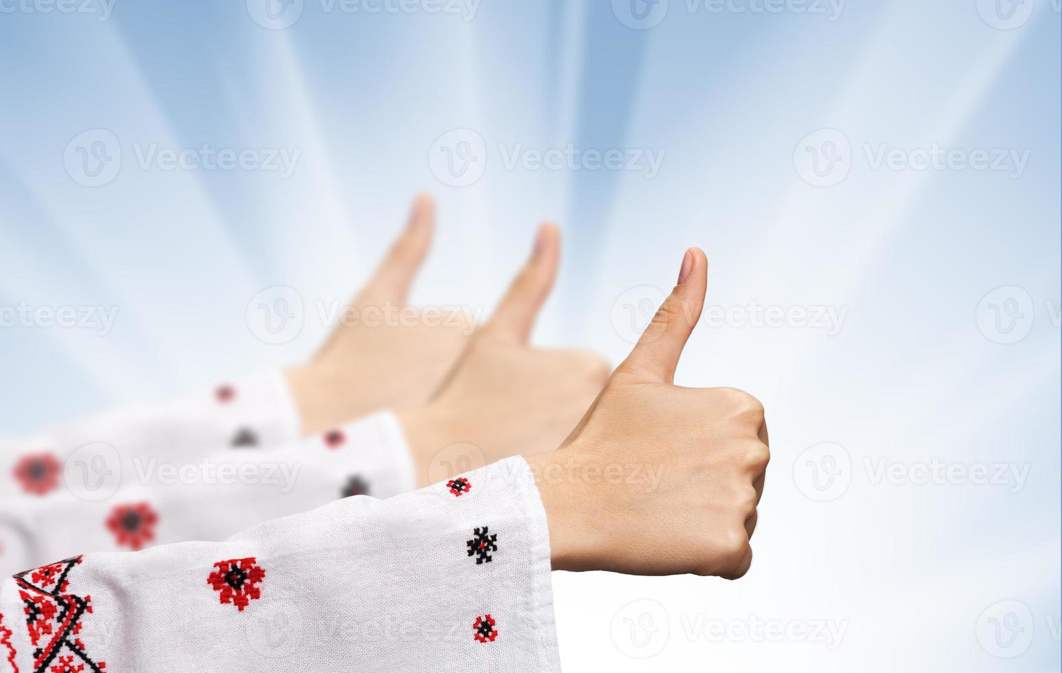 female hands in the Ukrainian national clothes shows symbol ok photo