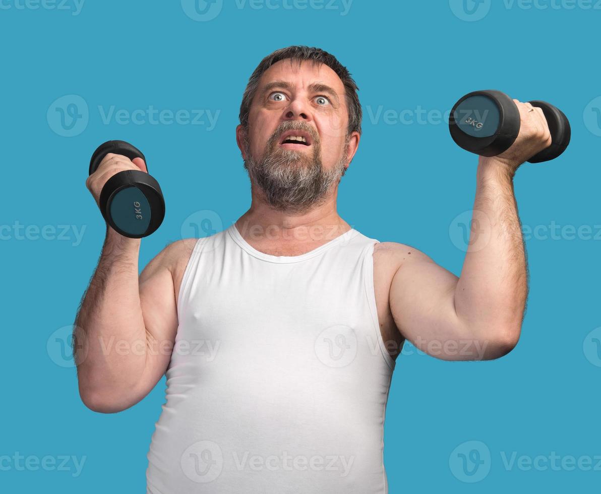 man exercising with dumbbells photo