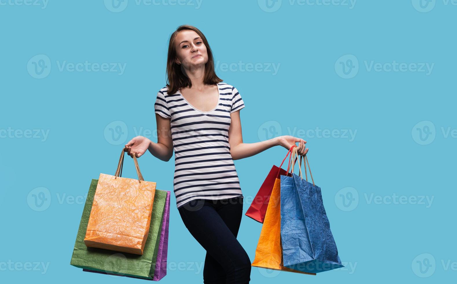 Happy young woman with shopping bags photo