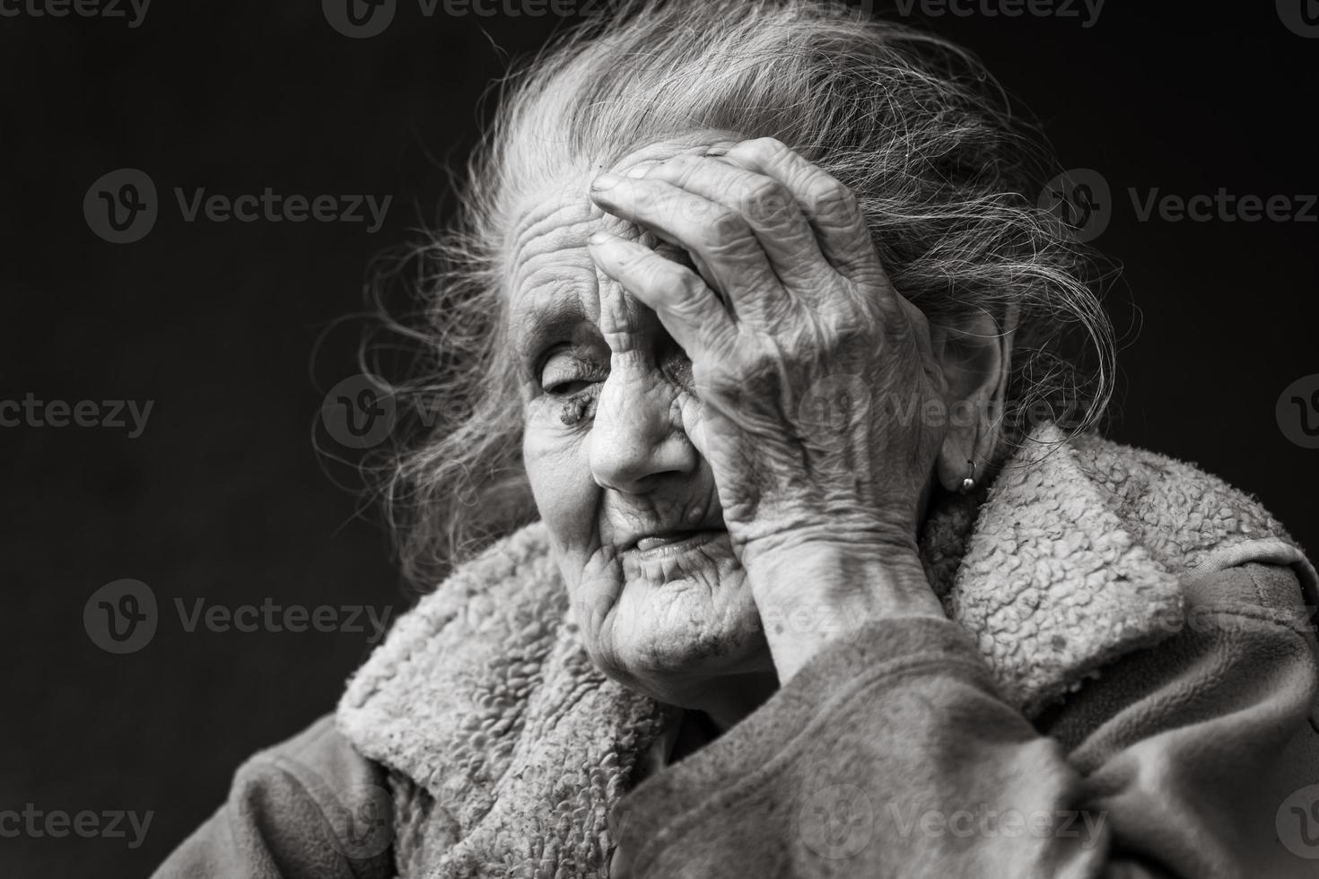 Very old and tired wrinkled woman outdoors photo