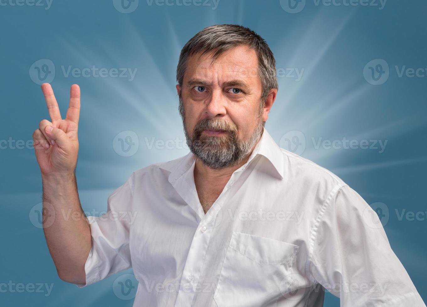 Man in  showing victory sign photo