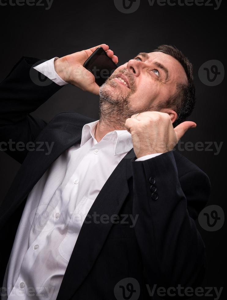 business man speaks on a mobile phone photo