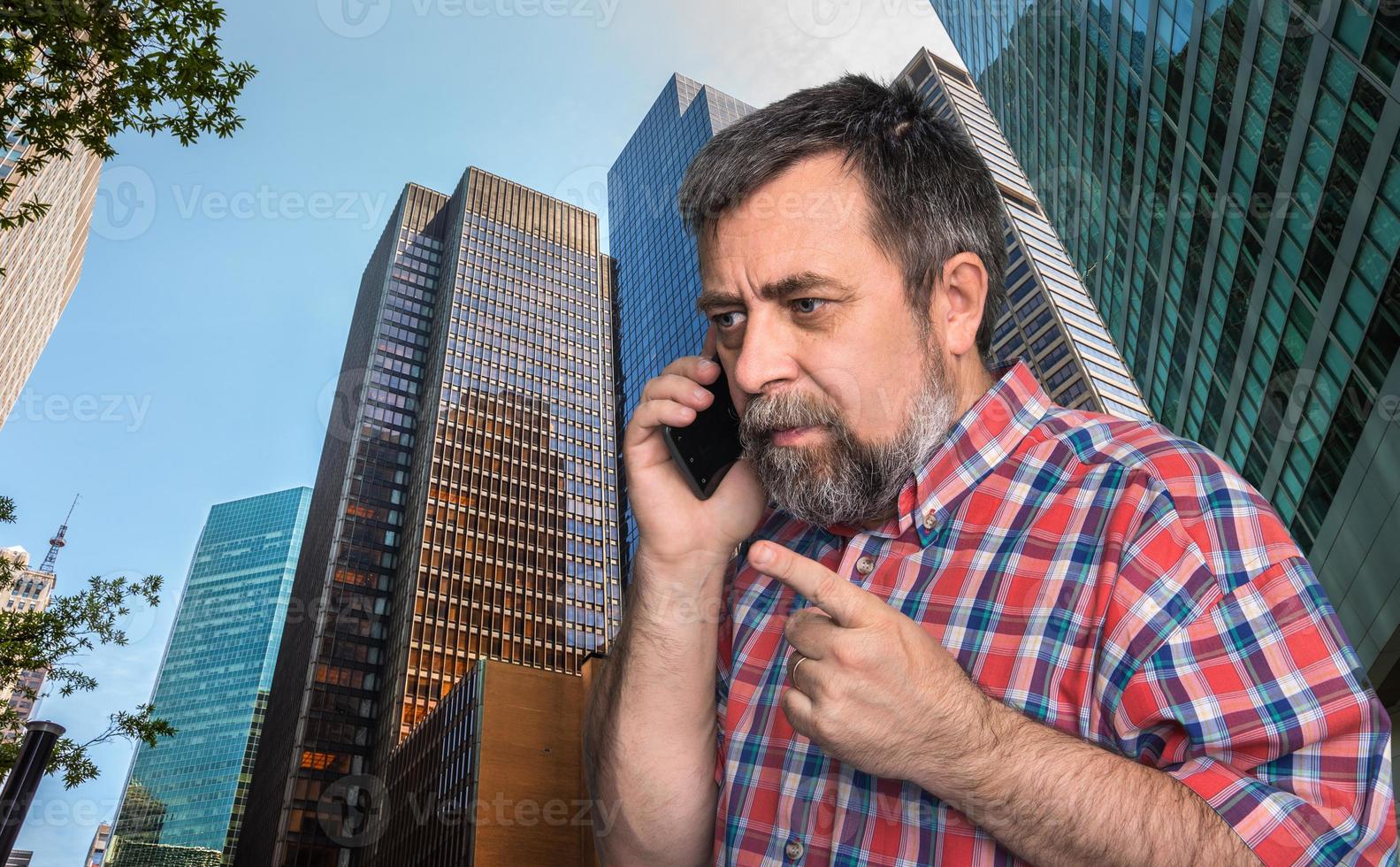 businessman talking on mobile phone in the megalopolis photo