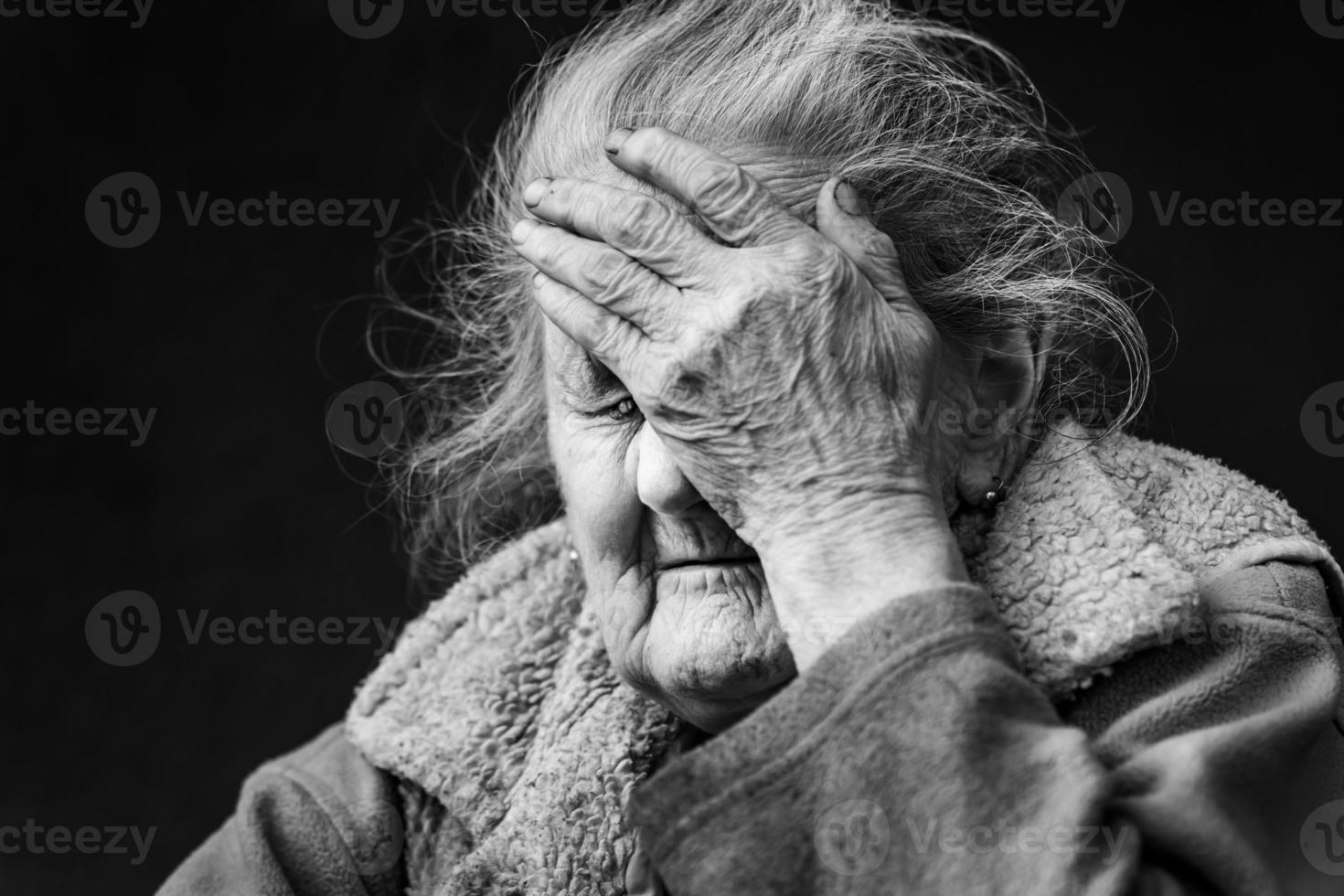 Very old and tired wrinkled woman outdoors photo