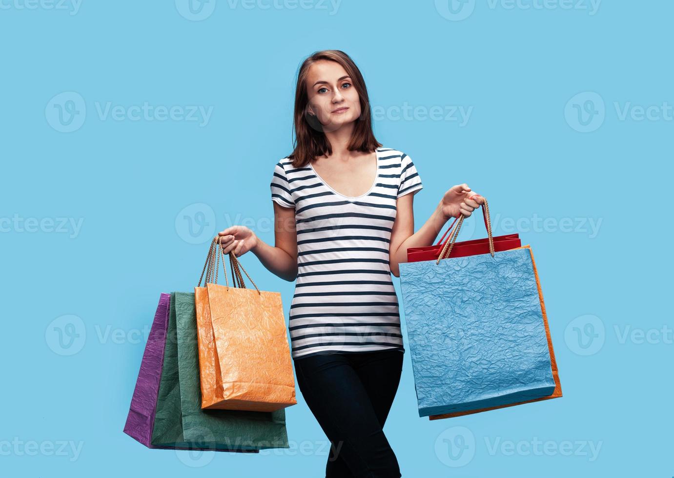 Happy young woman with shopping bags photo