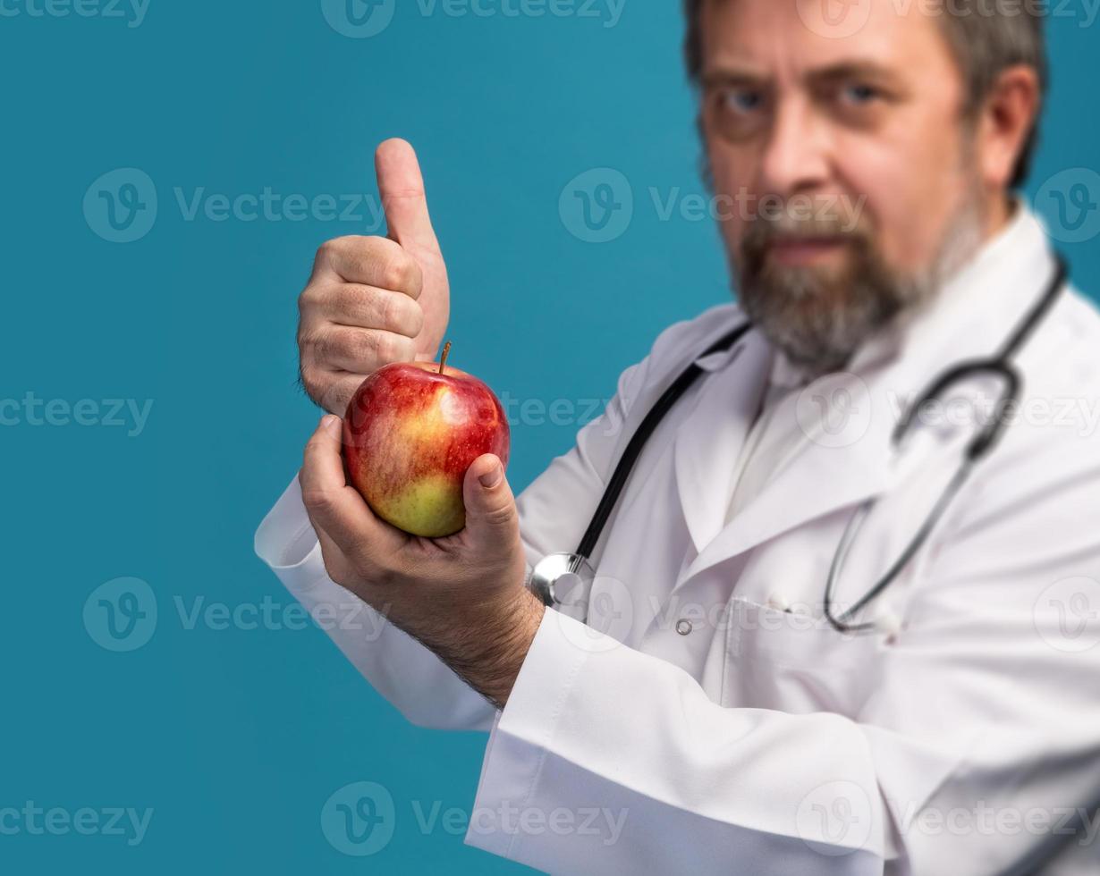 Doctor giving apple for healthy eating photo