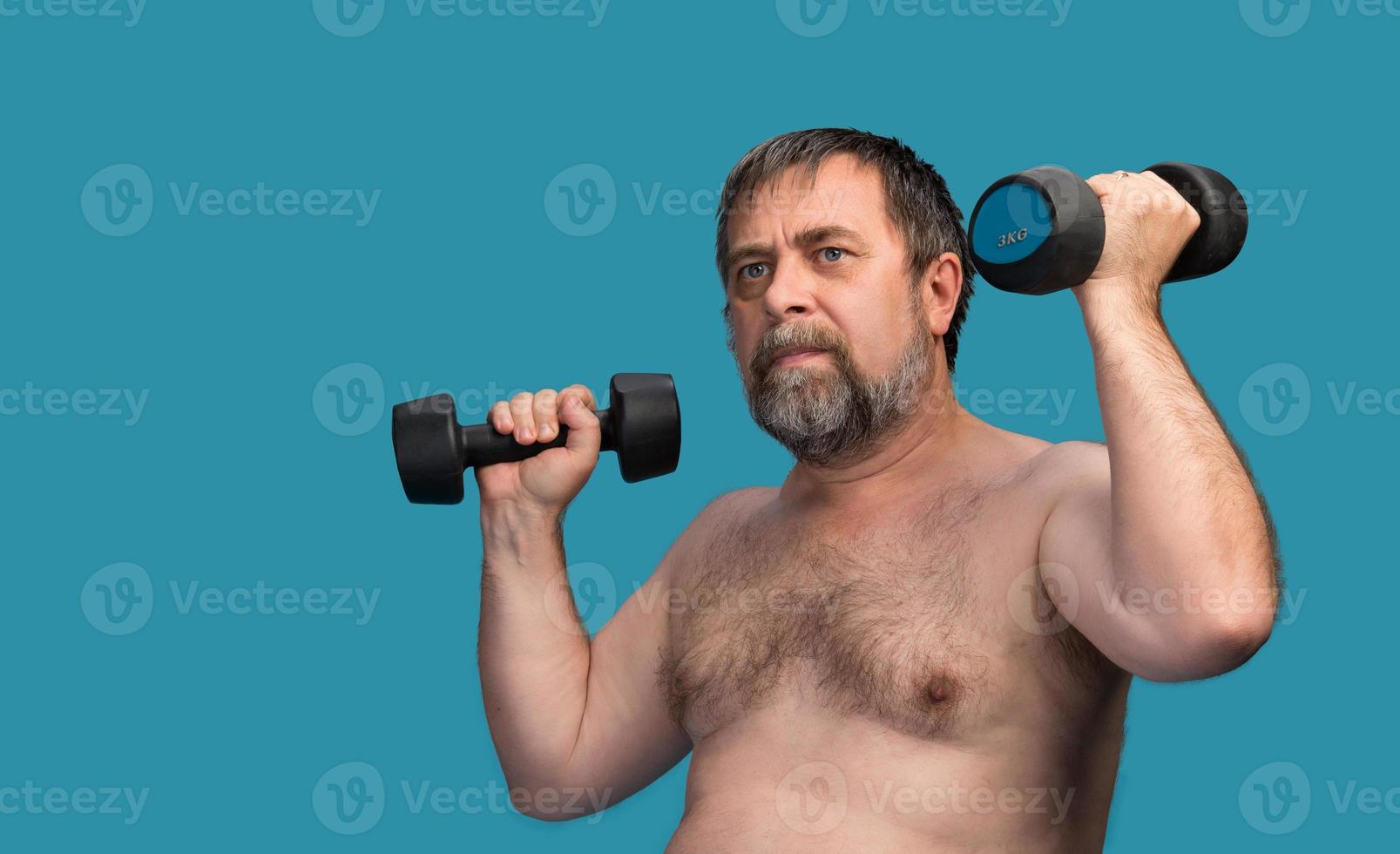 man exercising with dumbbells photo