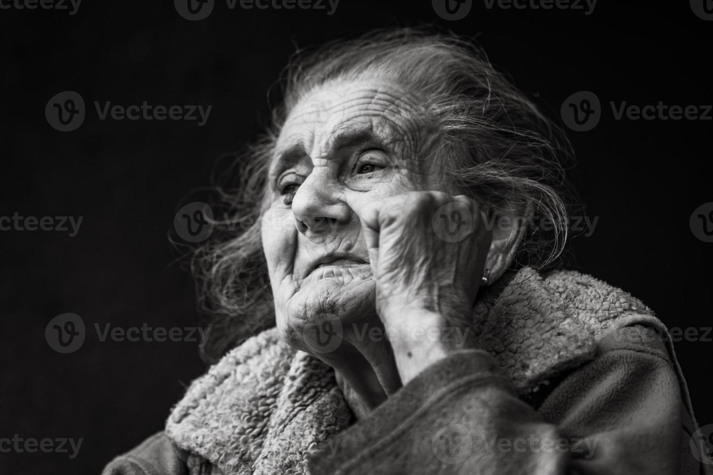 Very old and tired wrinkled woman outdoors photo