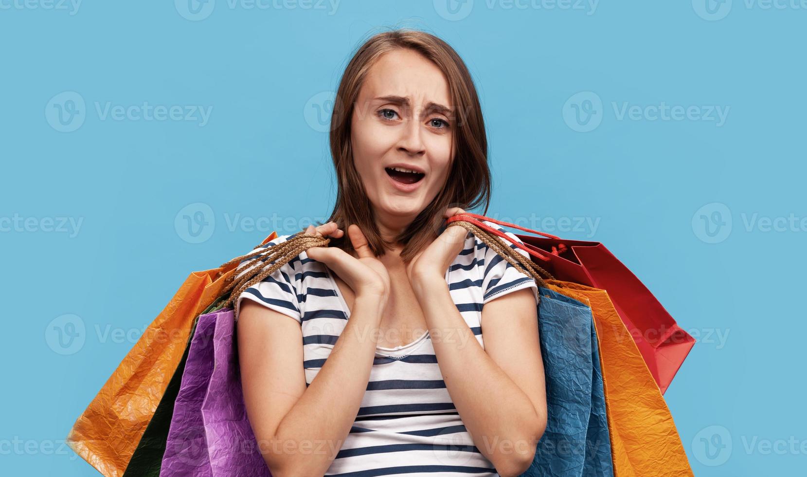 Happy young woman with shopping bags photo