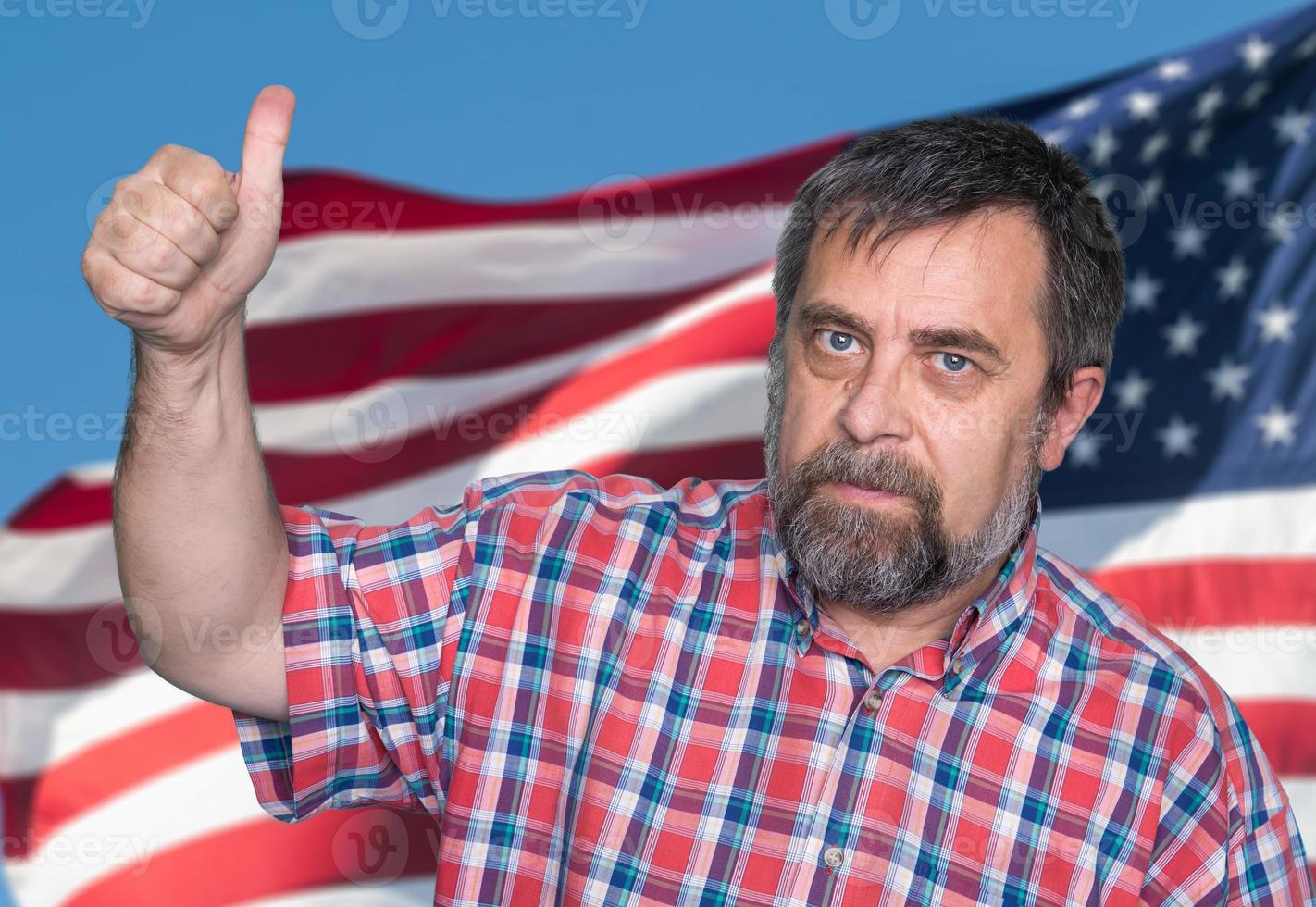 man tumb up against of USA flag photo