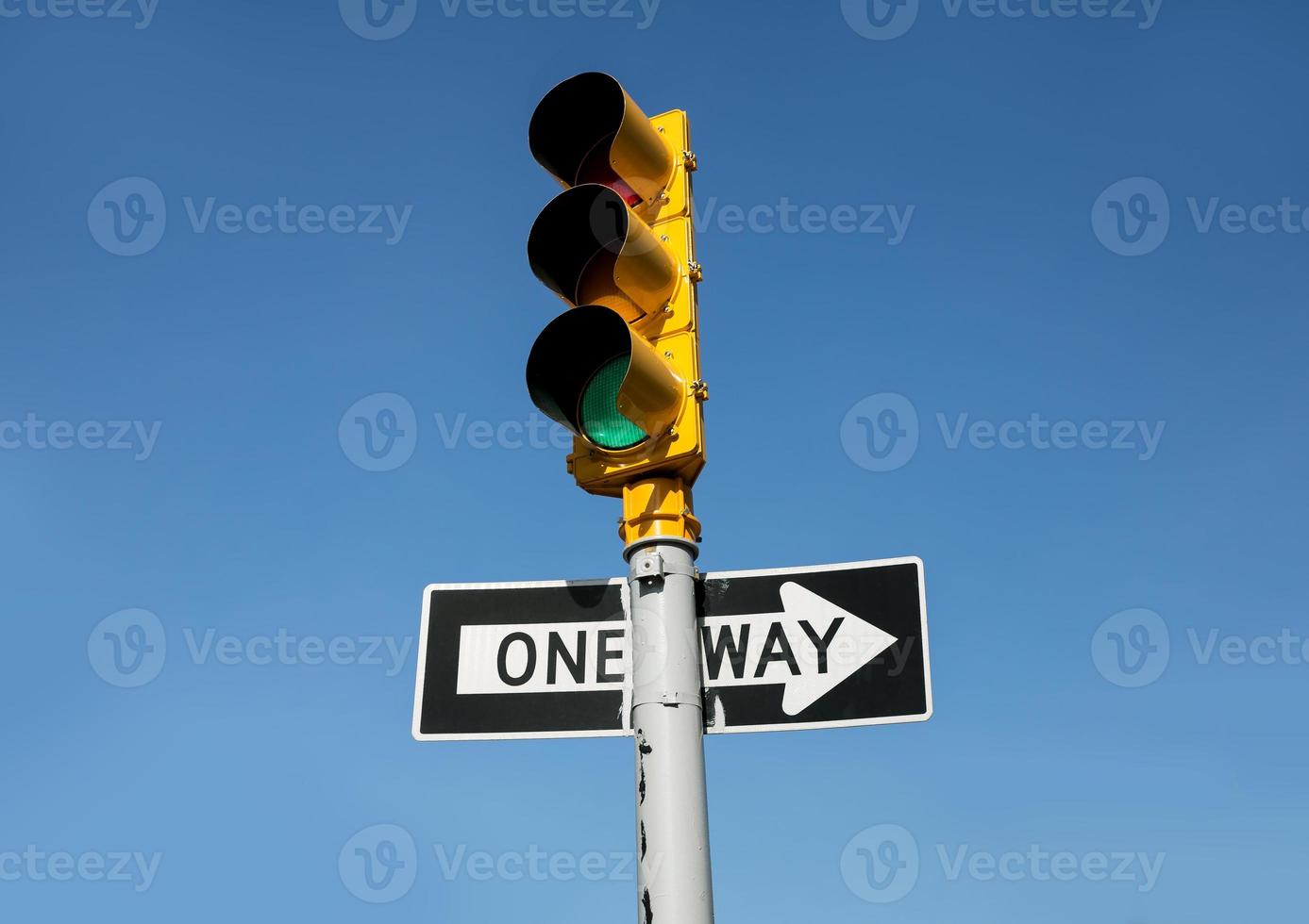 Traffic light and One Way road sign photo