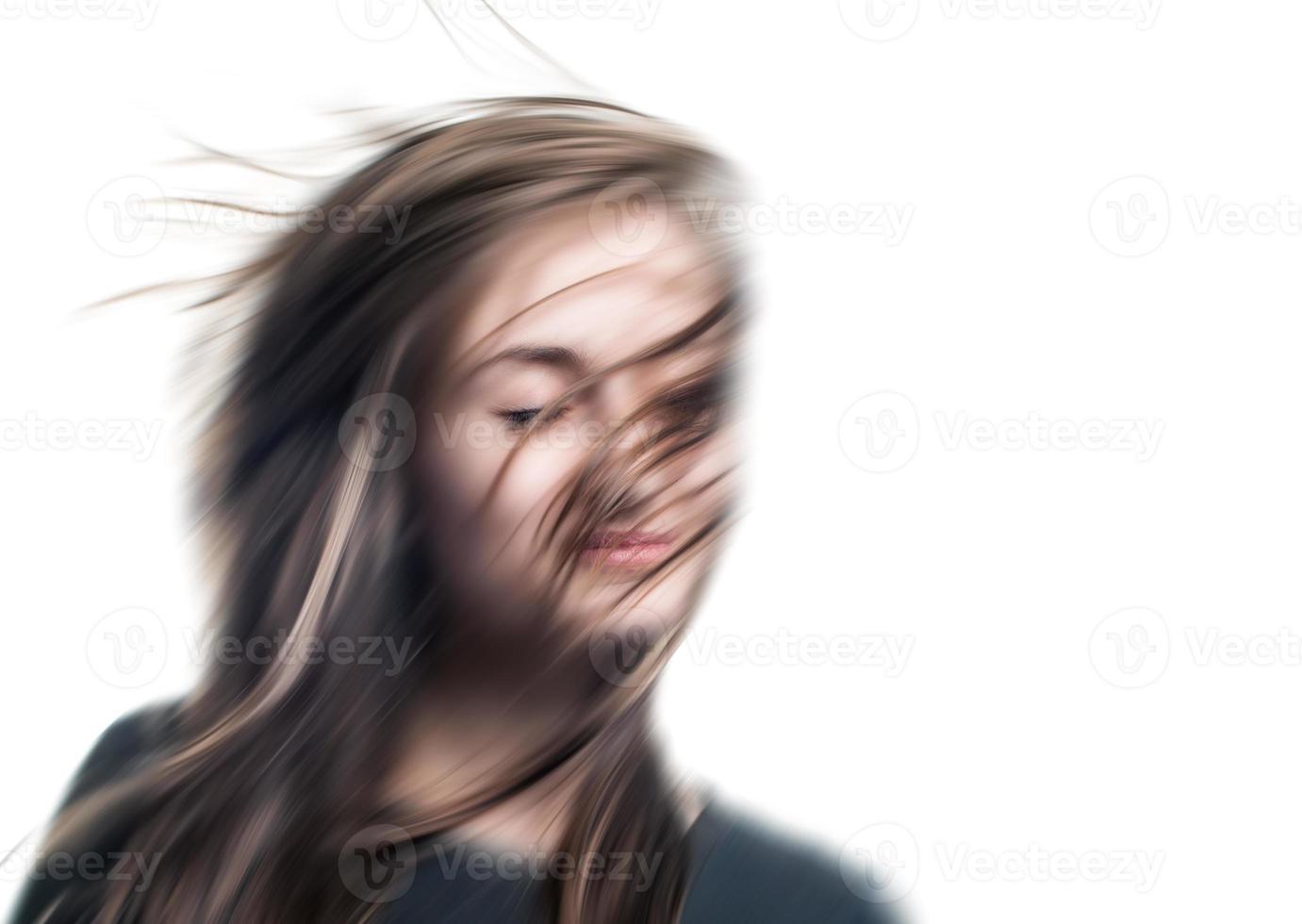 Blurred image of a young woman with eyes closed photo