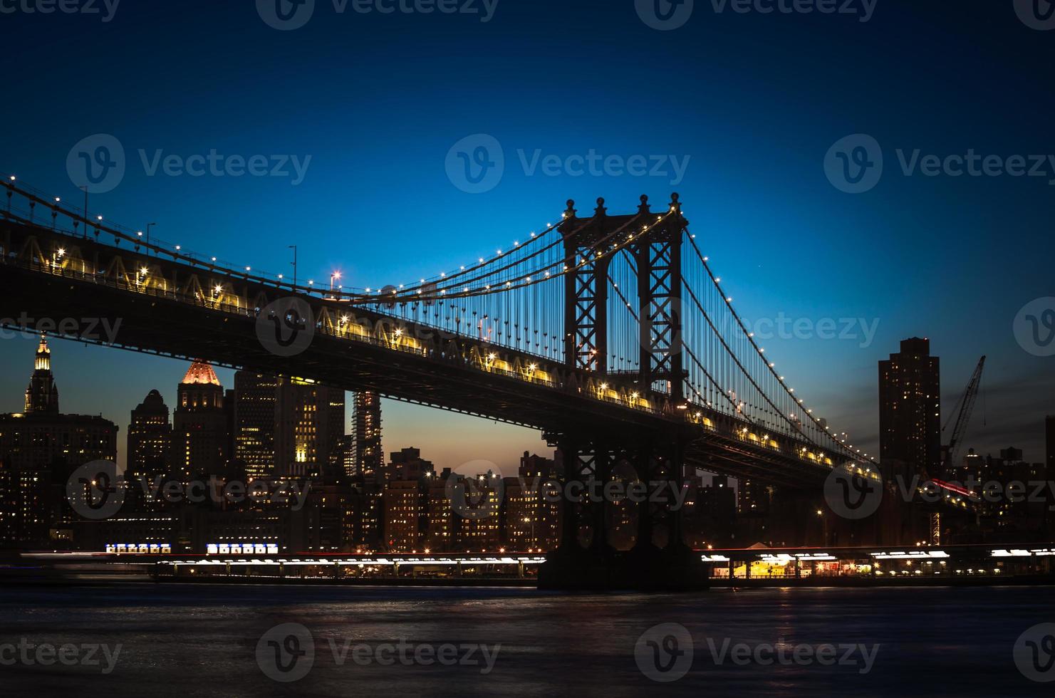 Silhouette of Manhattan Bridge at night photo