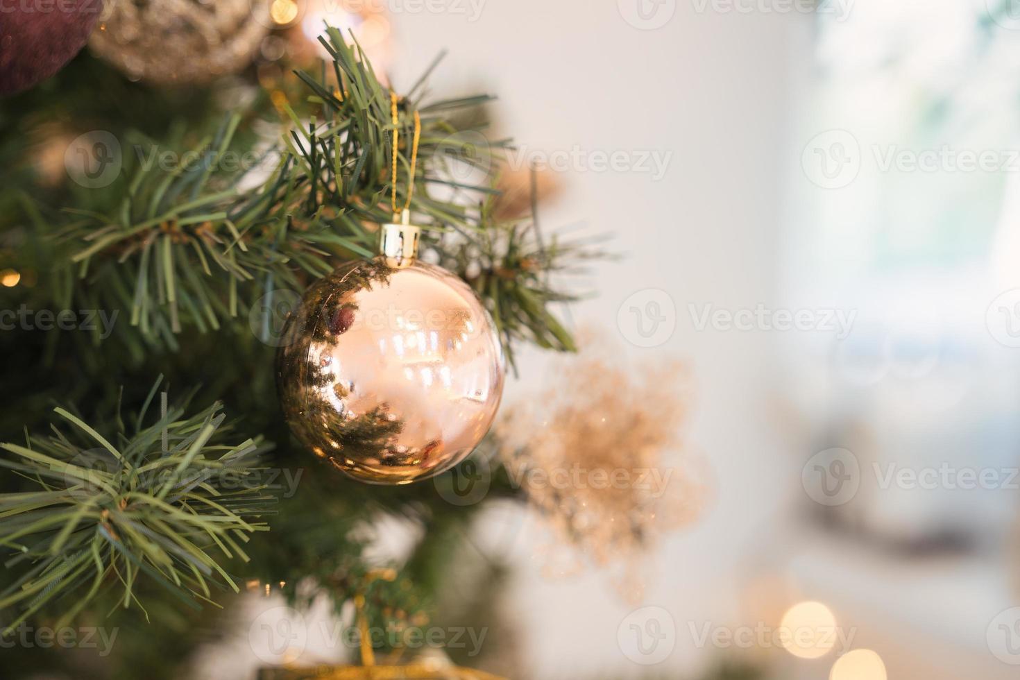 Christmas pine tree with decorative golden ball and bauble ornamental photo