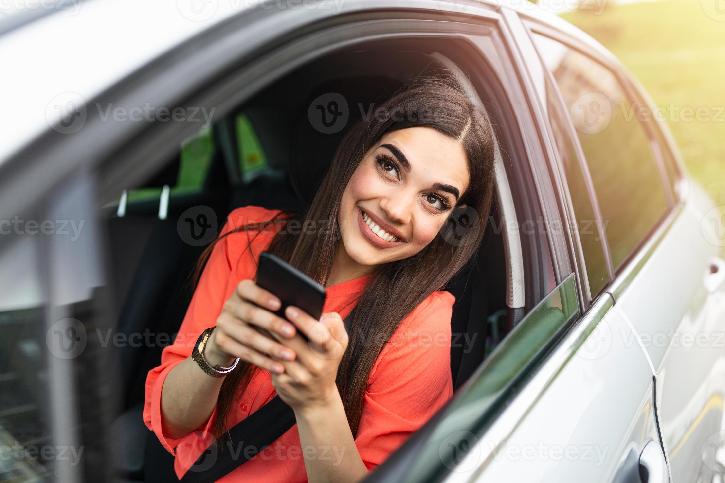 Woman driver using a smart phone in car. Woman driver using a smart