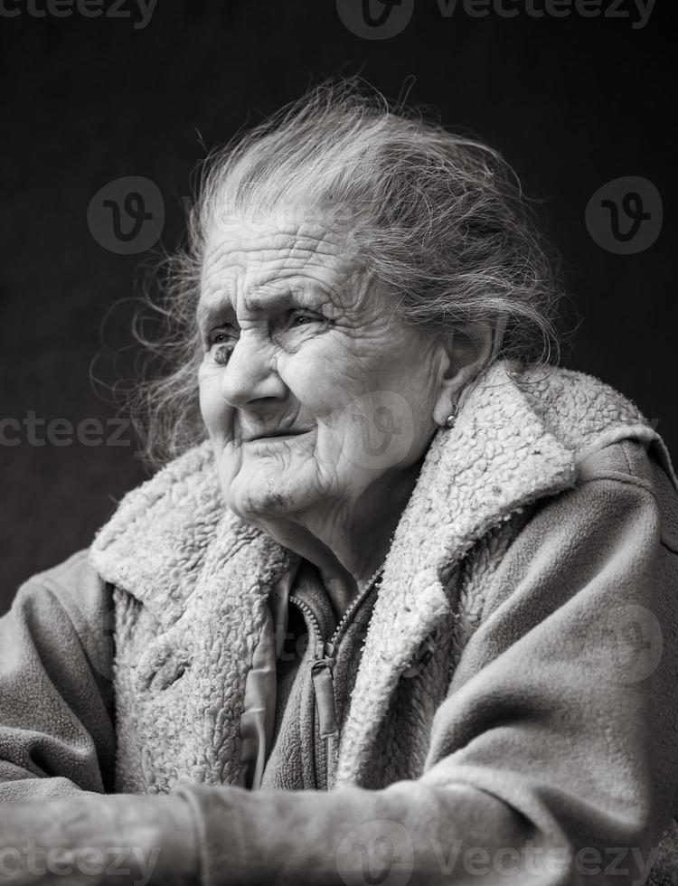 Very old and tired wrinkled woman outdoors photo