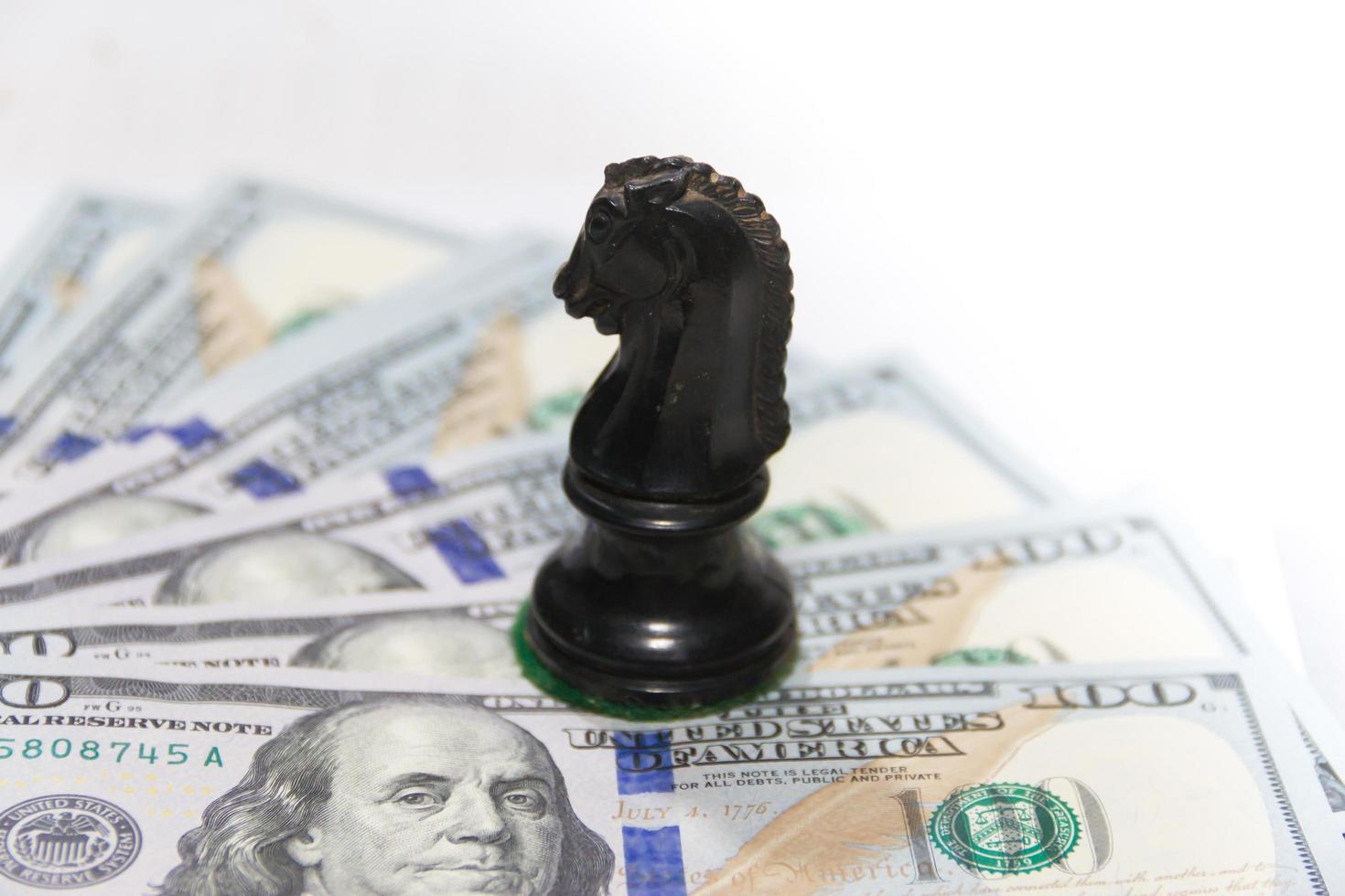 concepto de finanzas con billetes de dólar y caballo de ajedrez foto