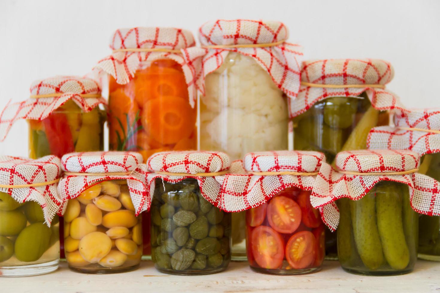 variety of jars with organic vegetable pickles photo