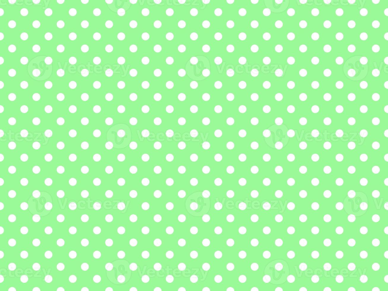 white polka dots over pale green background photo