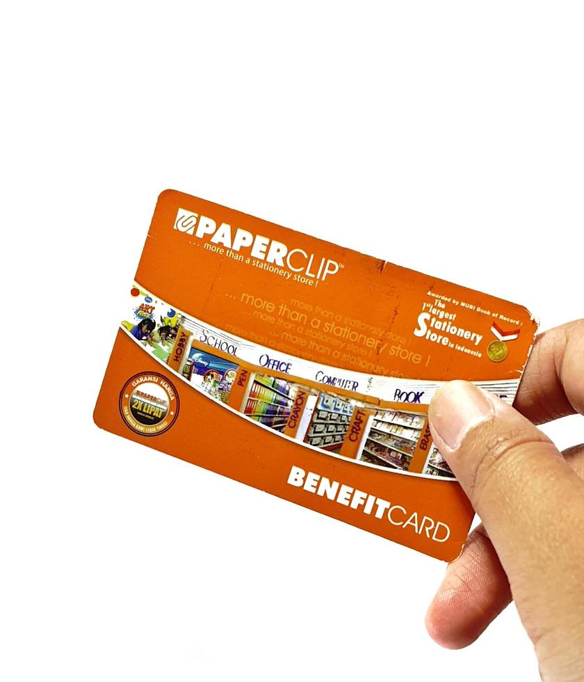 West Java, Indonesia on July 2022. Isolated photo of a hand holding a loyalty card, Benefit Card Paperclip.
