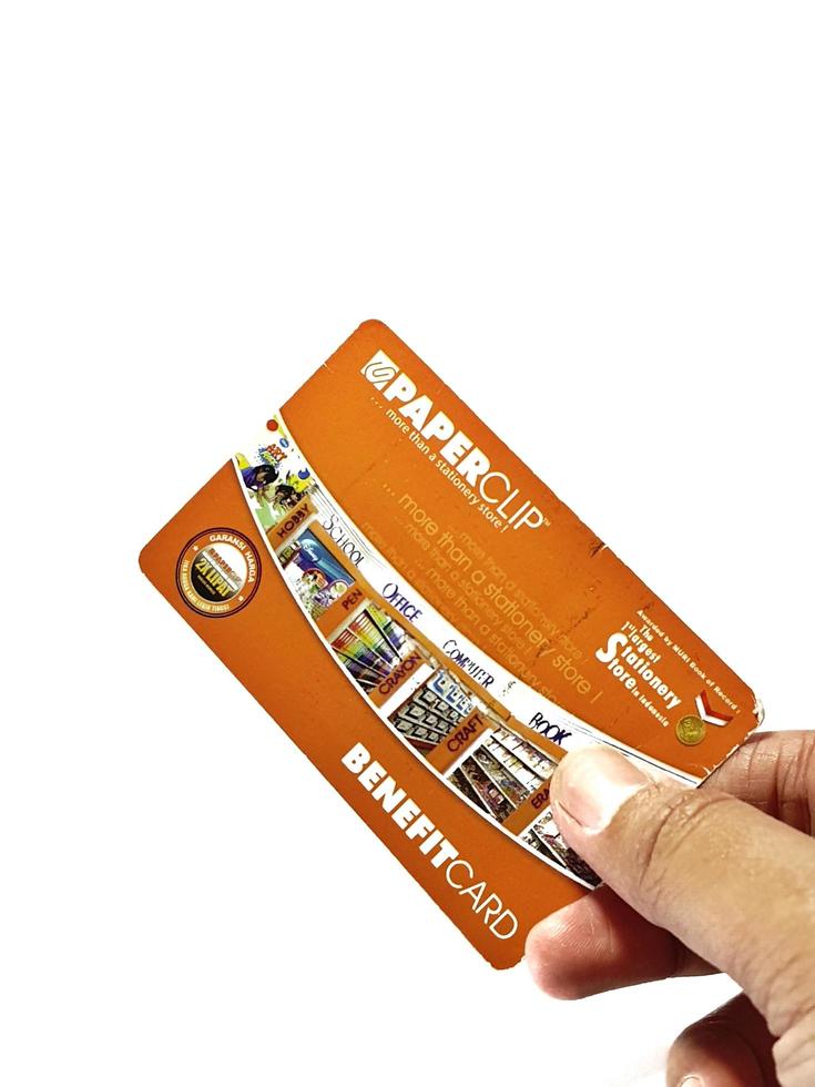 West Java, Indonesia on July 2022. Isolated photo of a hand holding a loyalty card, Benefit Card Paperclip.