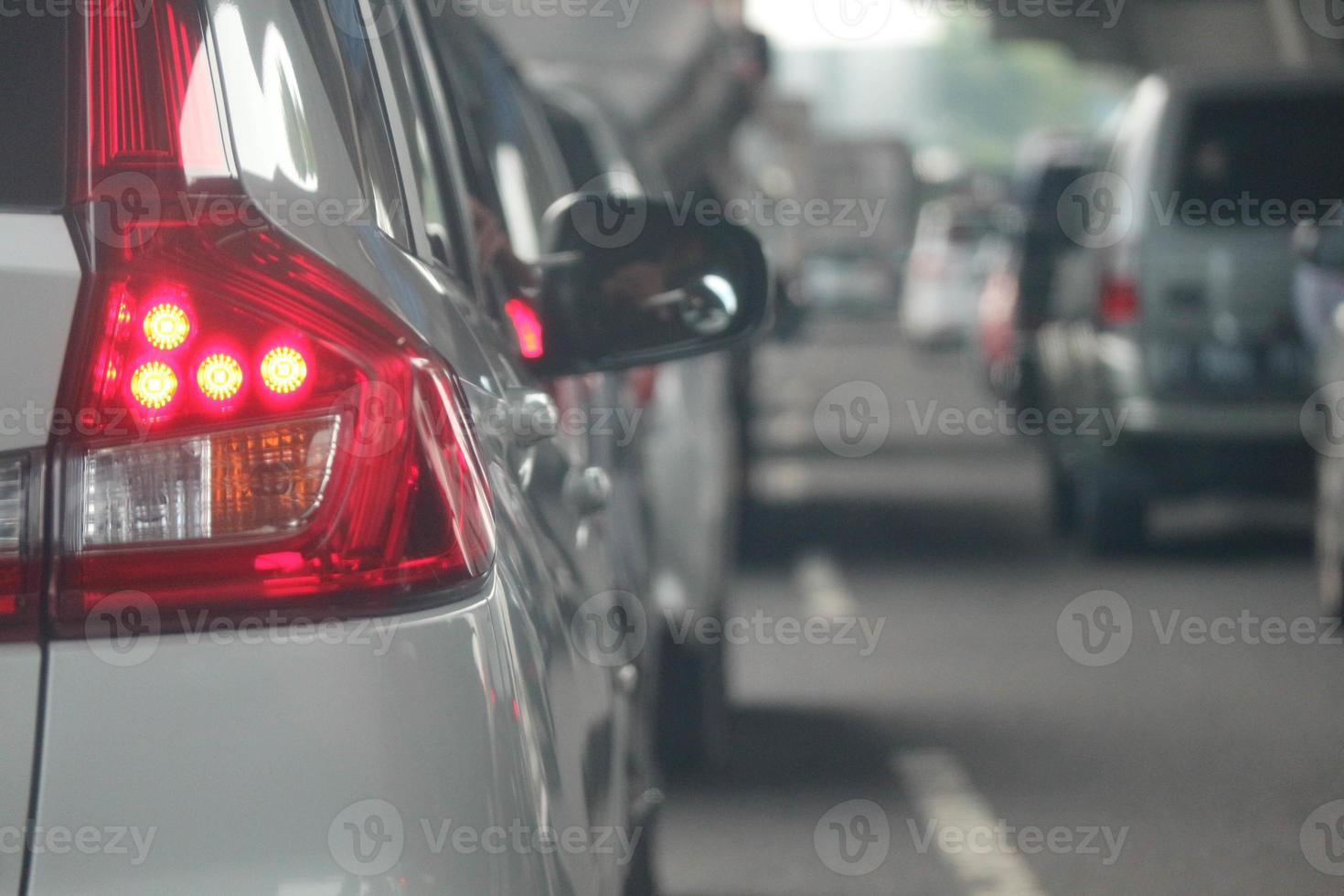 Close up photo of a back lamp of car that stuck in a traffic jam