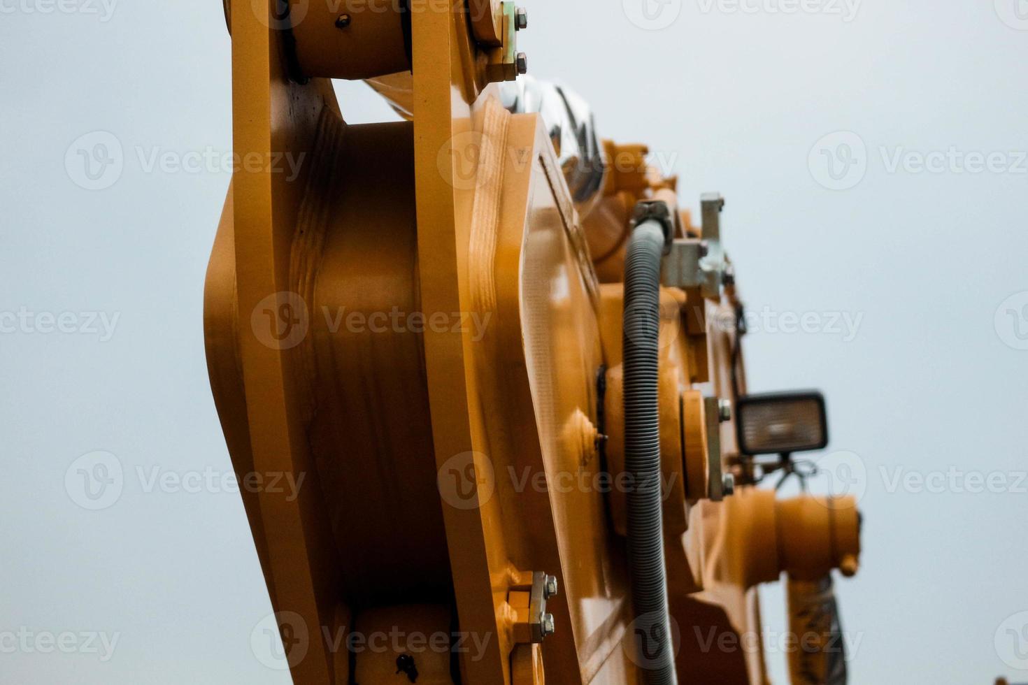 Close up detailed components of the yellow excavator photo