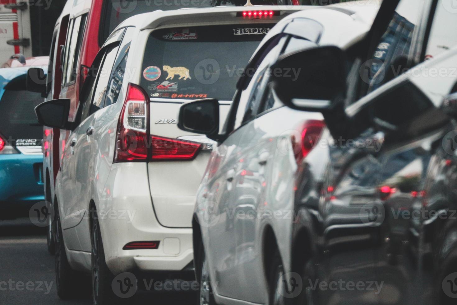 Close up photo of a back lamp of car that stuck in a traffic jam on the highway,