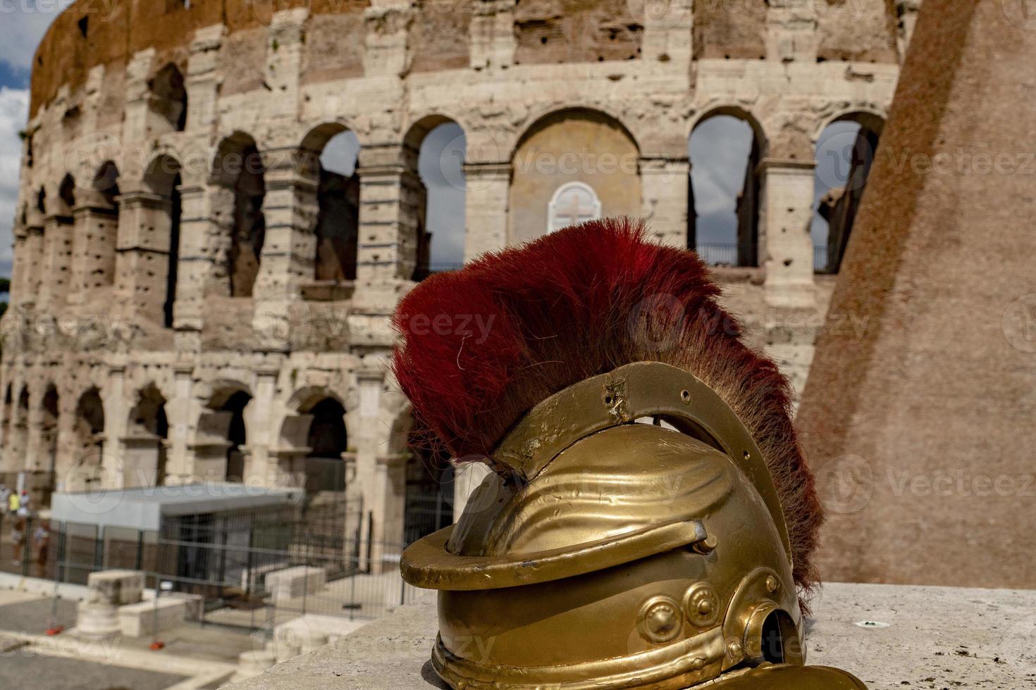 metallic gladiator helm on rome coliseum background photo