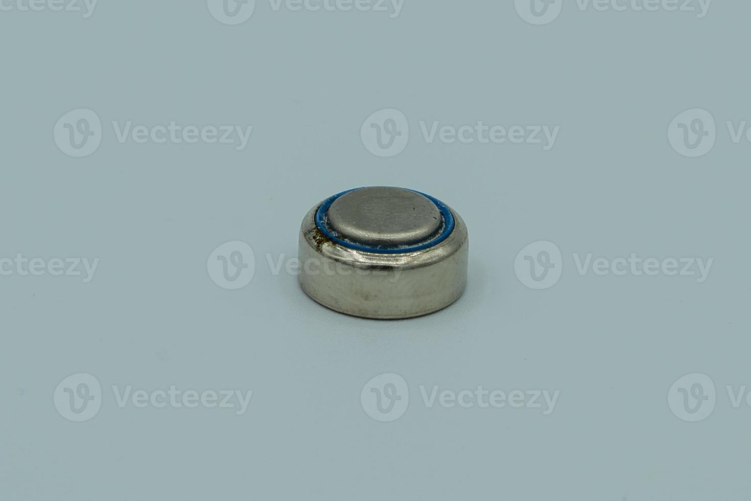 Button battery macro isolated on white photo