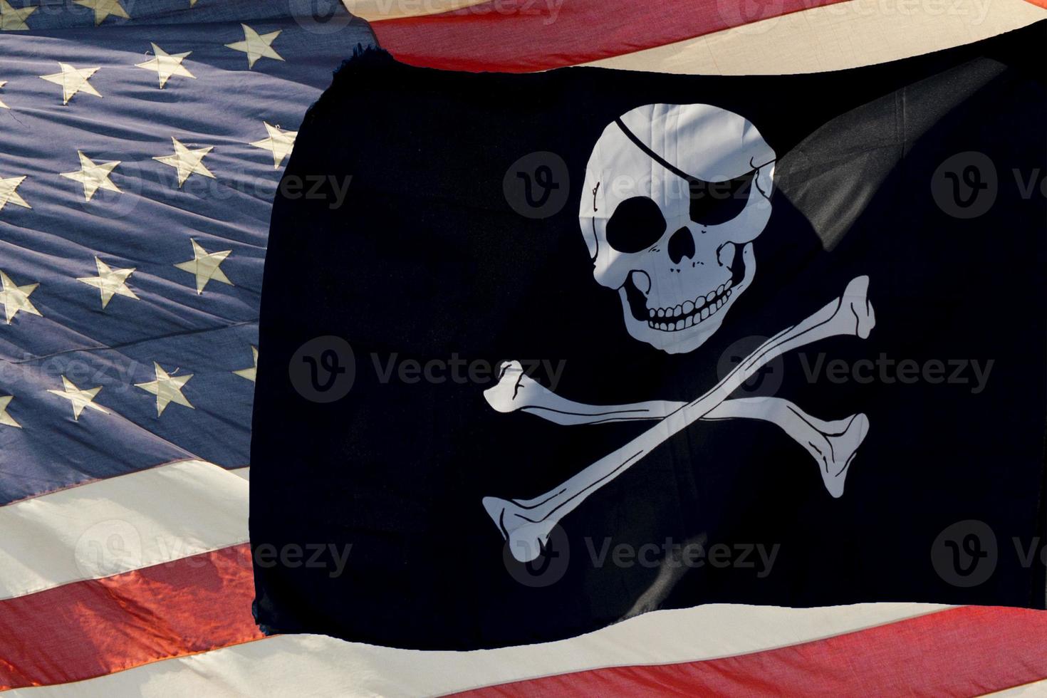 waving pirate flag jolly roger on usa star and stripes photo