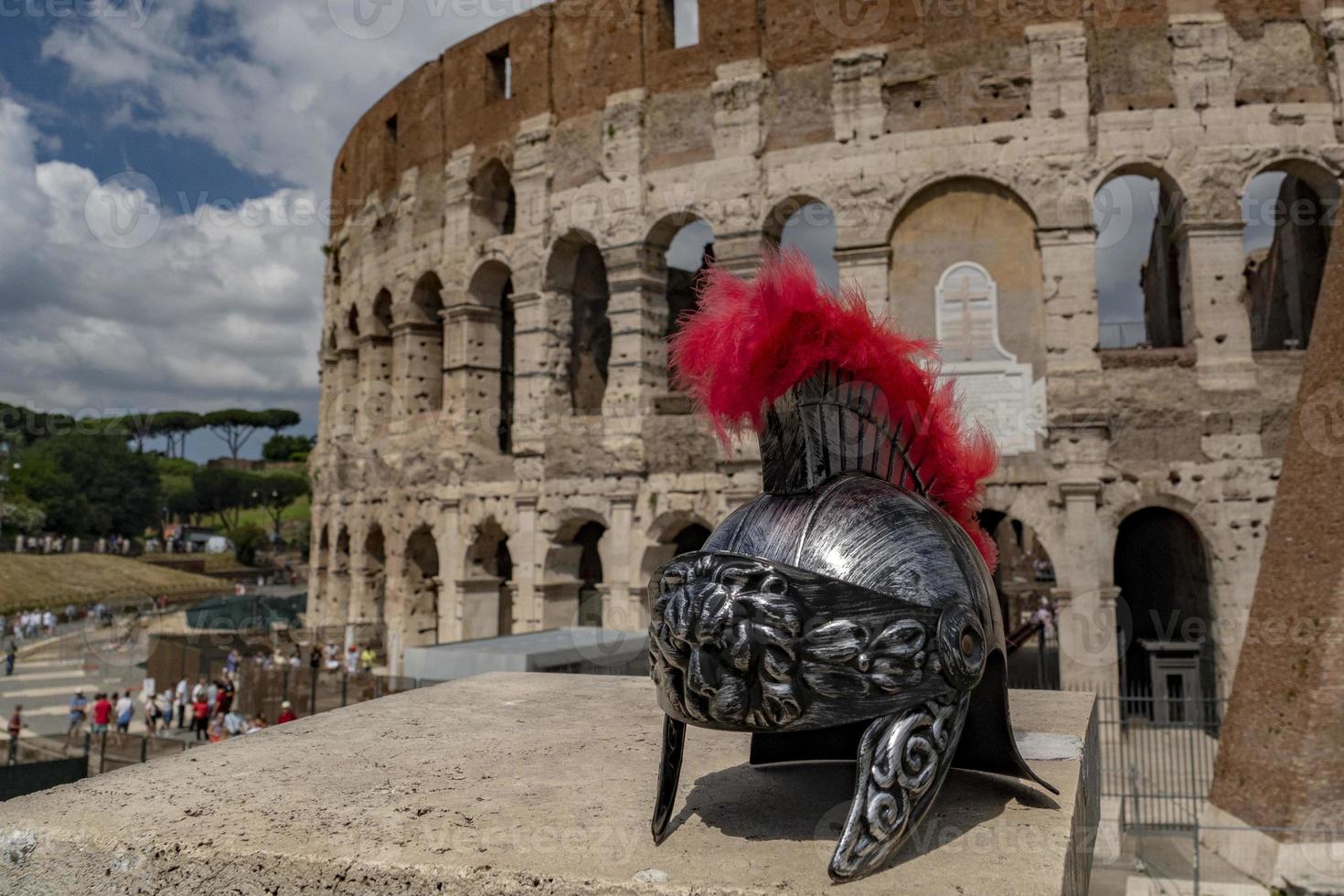 metallic gladiator helm on rome coliseum background photo