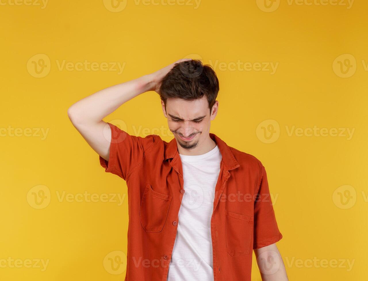 Portrait of thinking man surrounded by question mark on isolated background photo