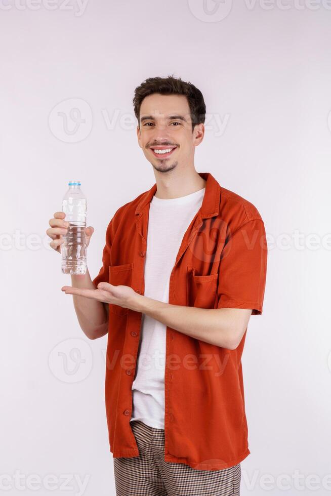 https://static.vecteezy.com/system/resources/previews/018/739/941/non_2x/portrait-of-happy-young-man-showing-water-in-a-bottle-isolated-over-white-background-photo.jpg