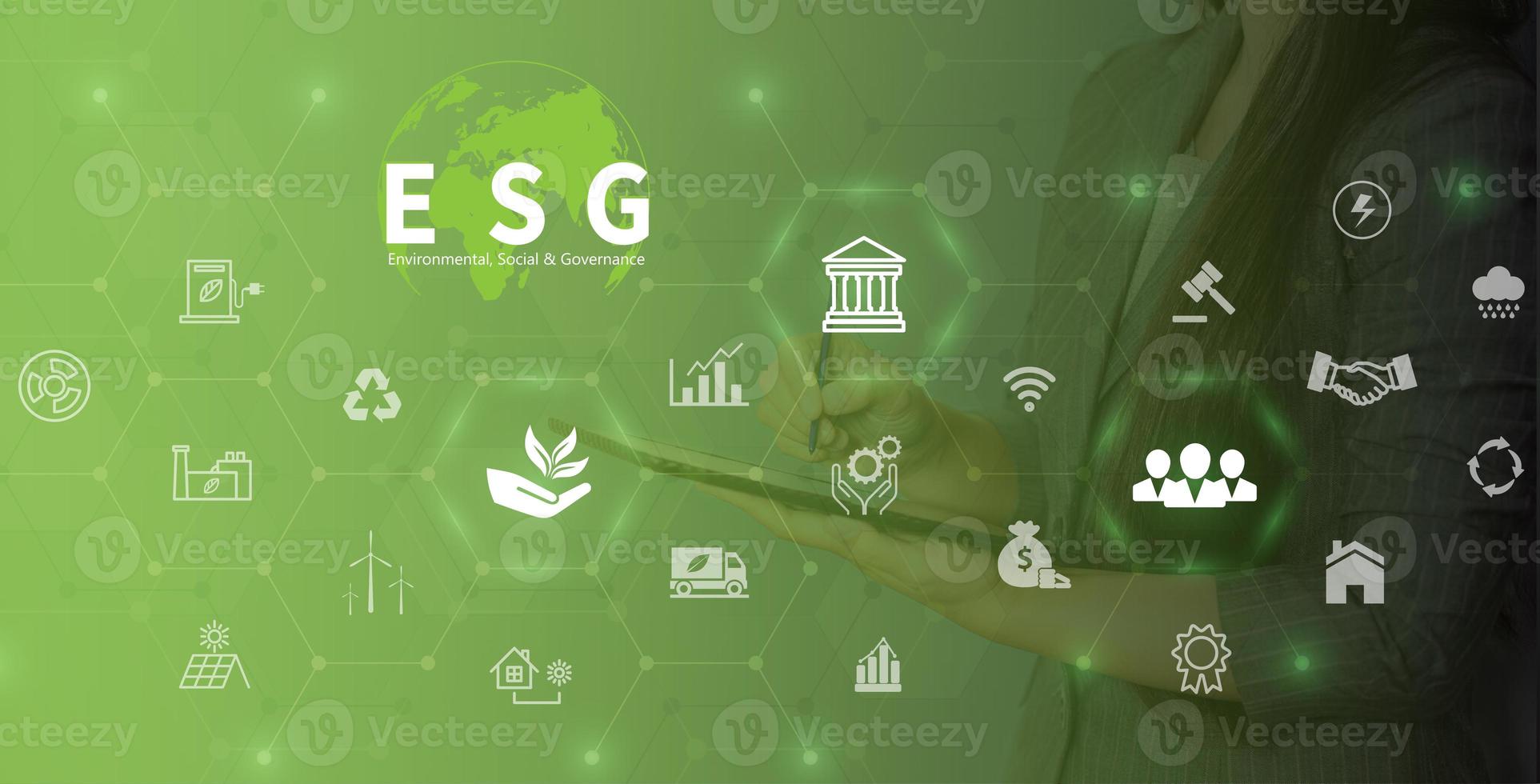 ESG environment social governance investment business concept. Women use a computer to analyze ESG, surrounded by ESG icons .close to the computer screen in business investment strategy concept. photo