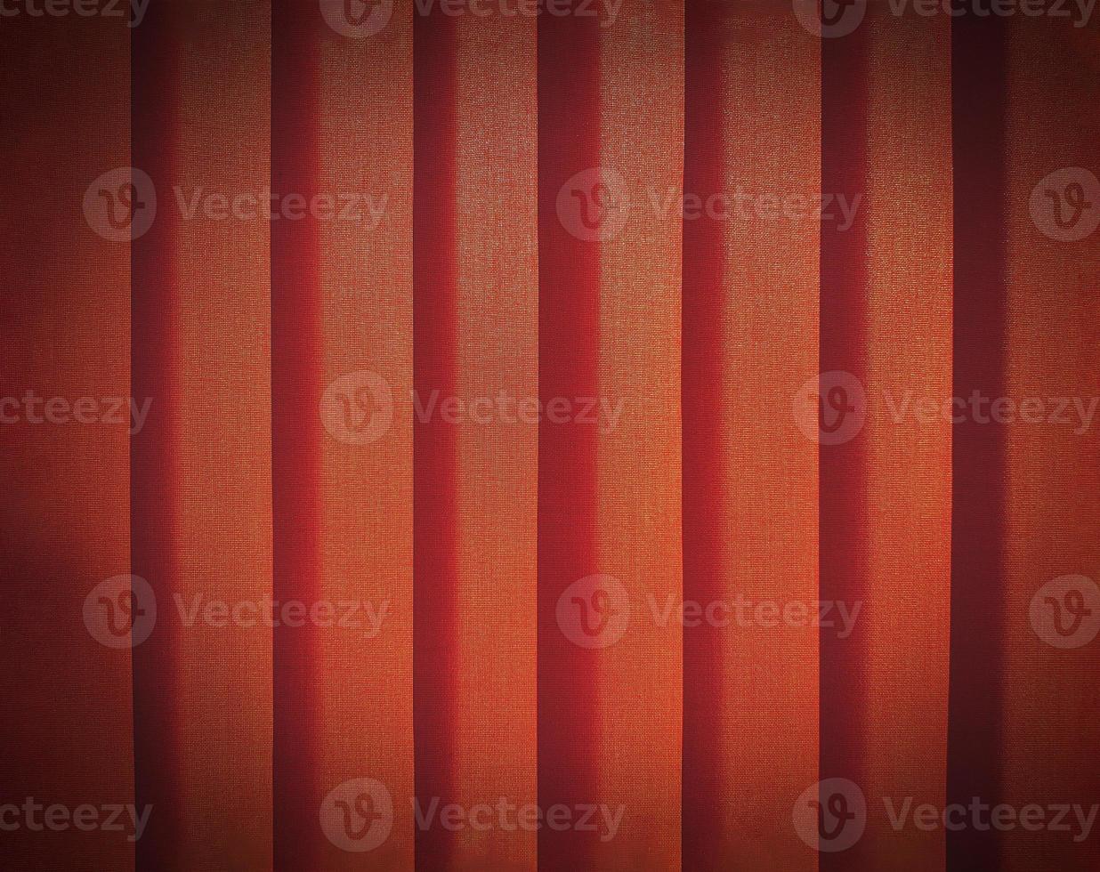 Close up pattern line of orange or red plastic curtain with vignette tone for background. Abstract, wall or wallpaper concept photo