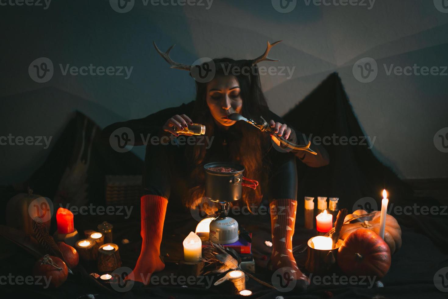 Close up female shaman tasting soup after adding spices portrait picture photo