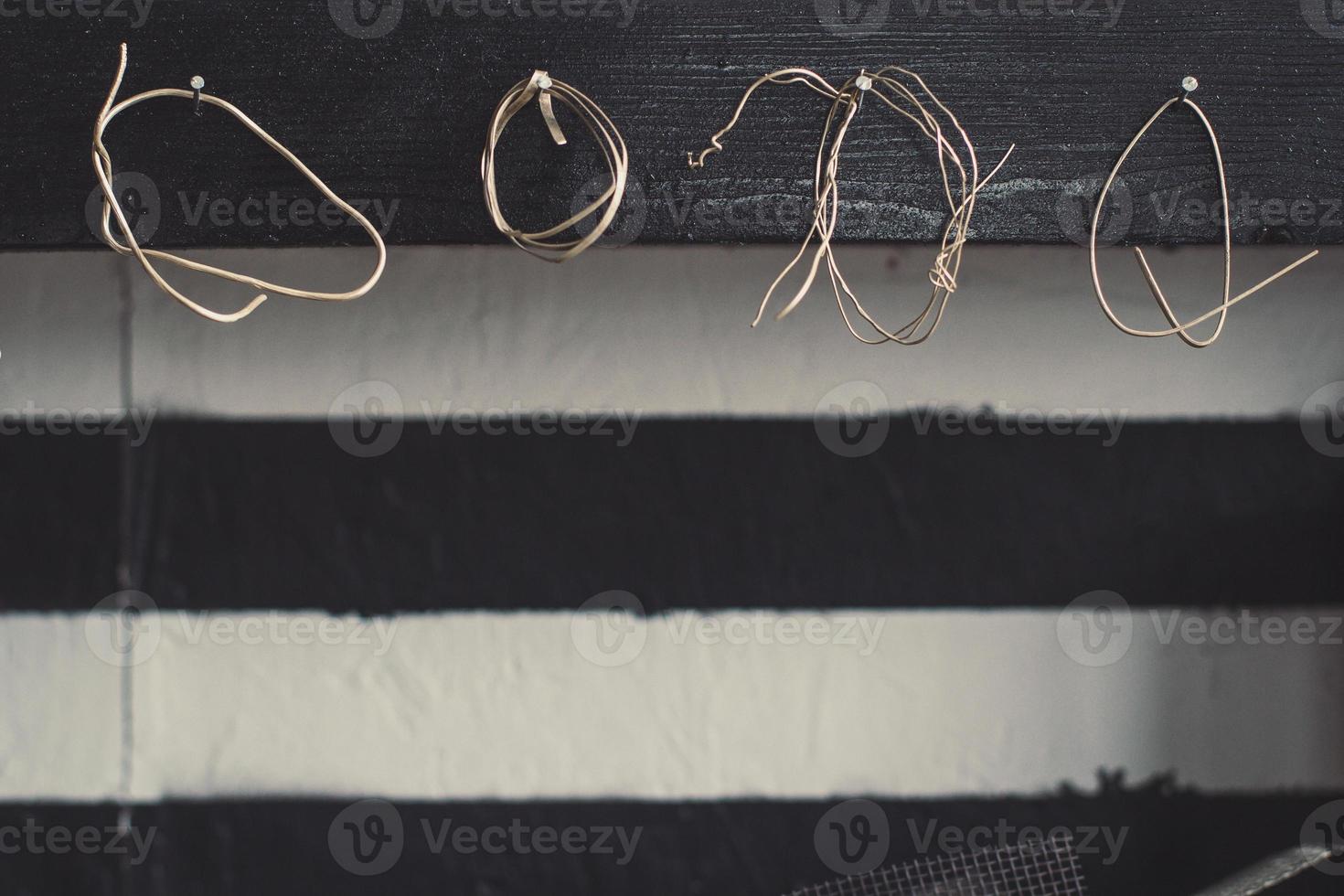 Close up twisted metallic wires hanging on nails concept photo