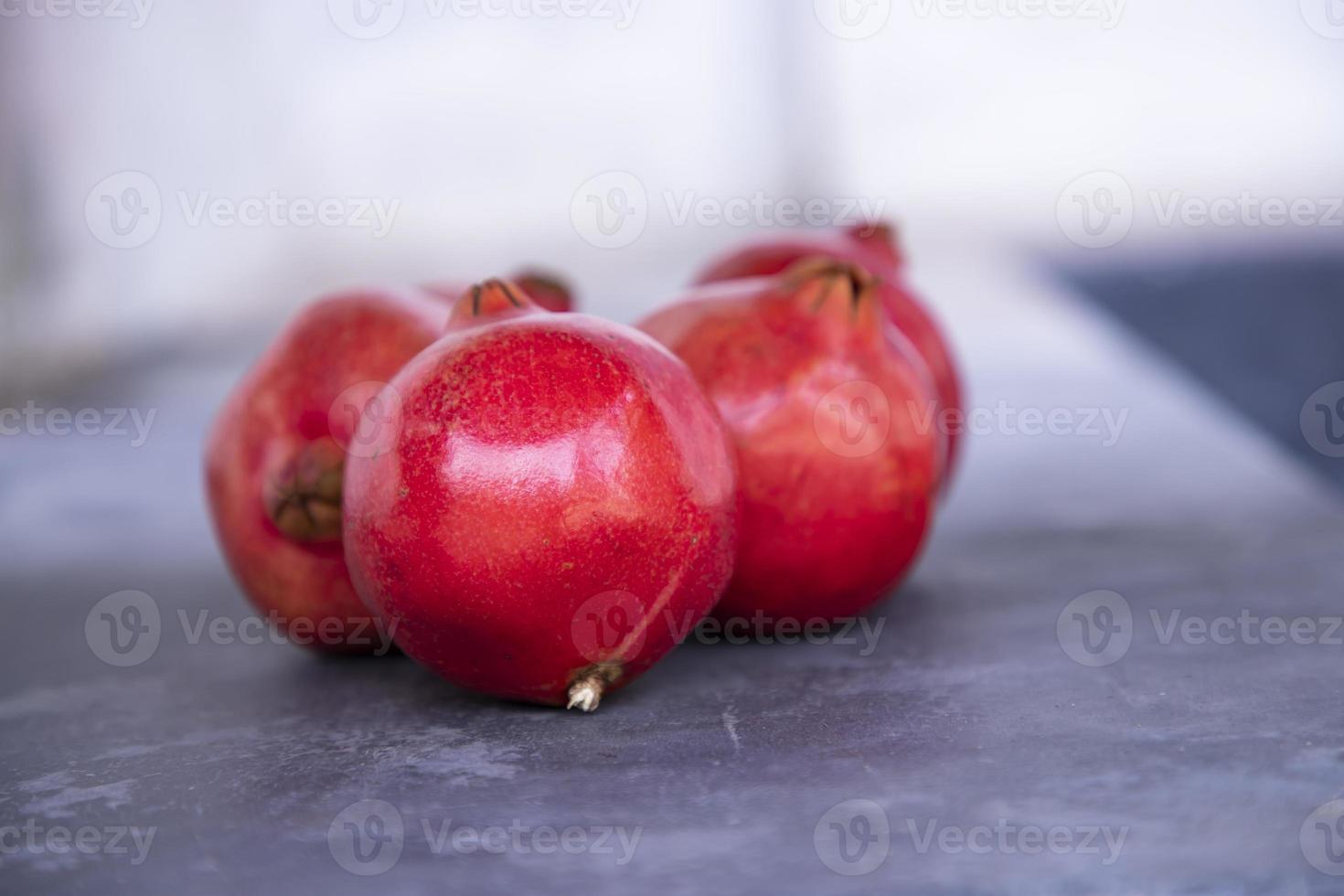 Ripe pomegranate fruit on a dark background close up photo
